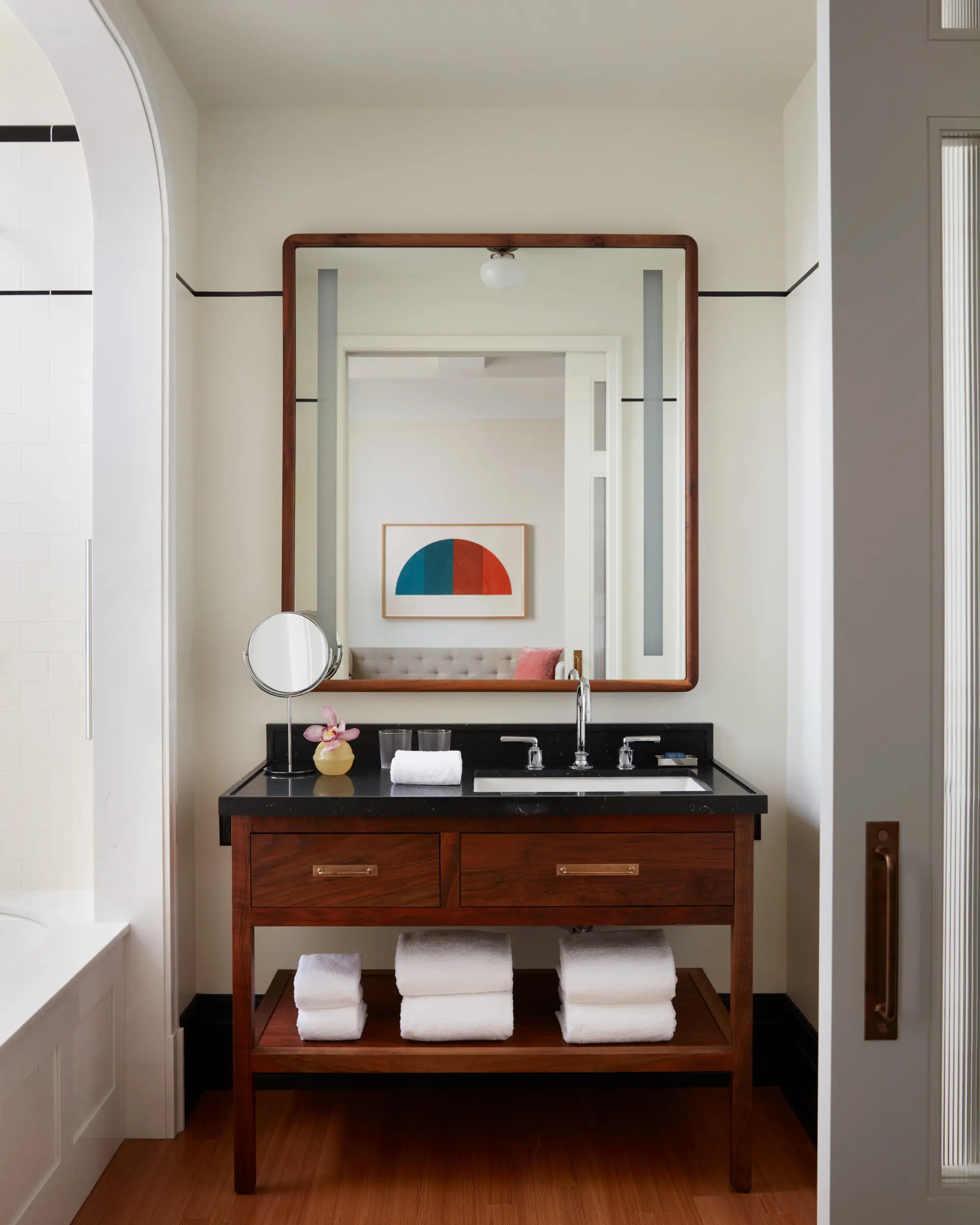 a bathroom vanity with a large square mirror