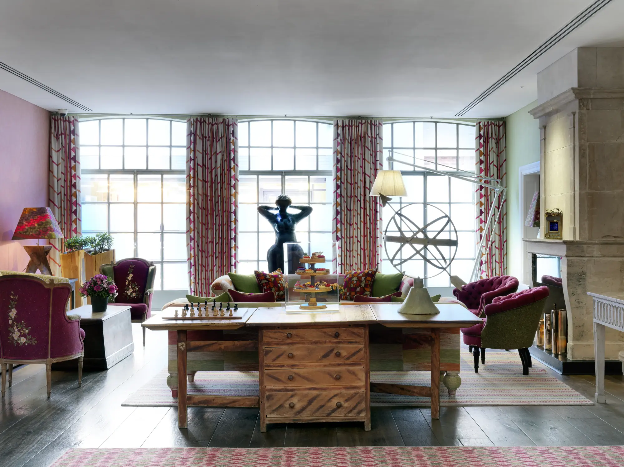 a luxe dining area with floor-to-ceiling windows and a smooth stone sculpture of a woman