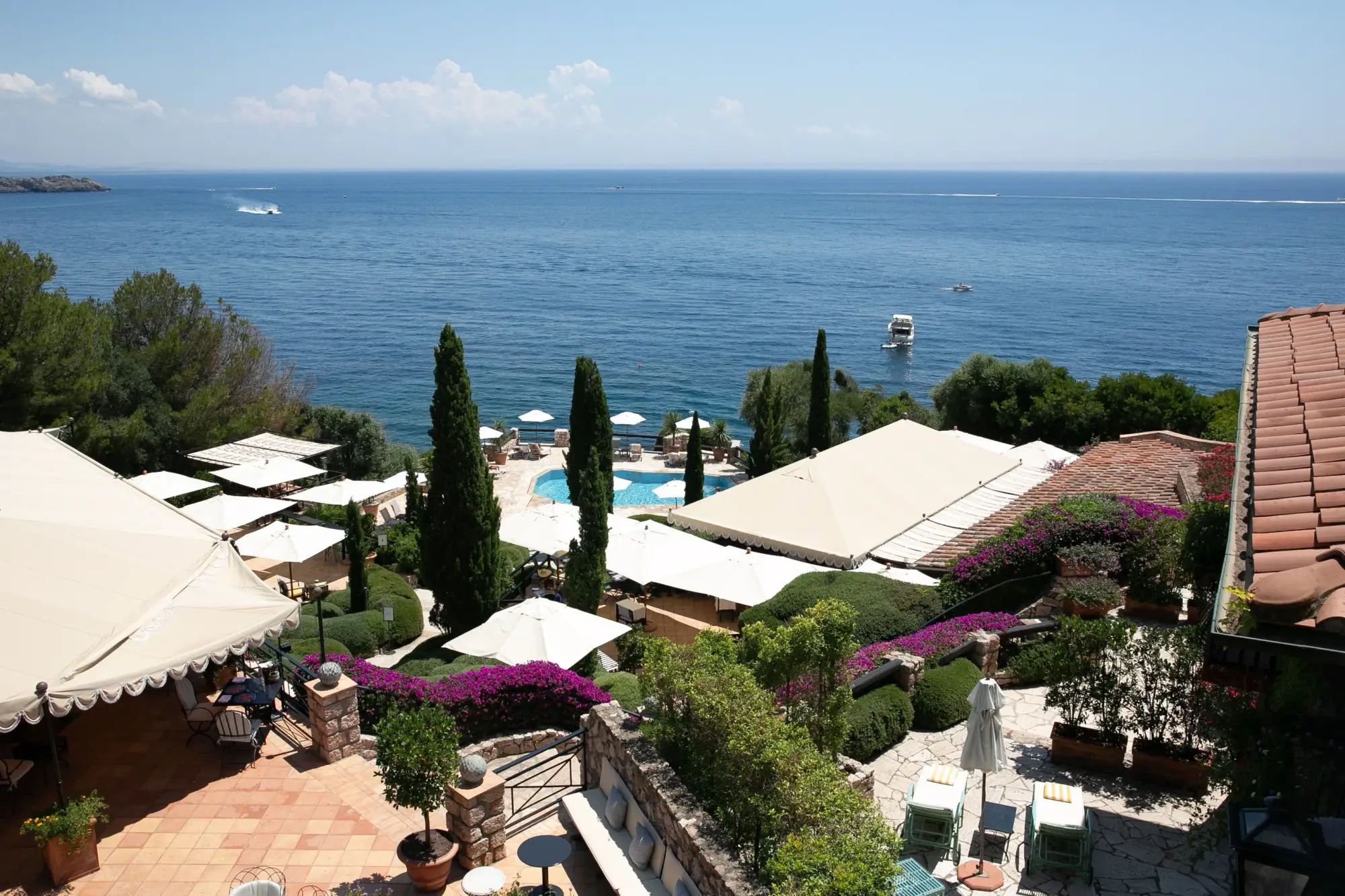 aerial view of a group of buildings overlooking an oceanfront pool