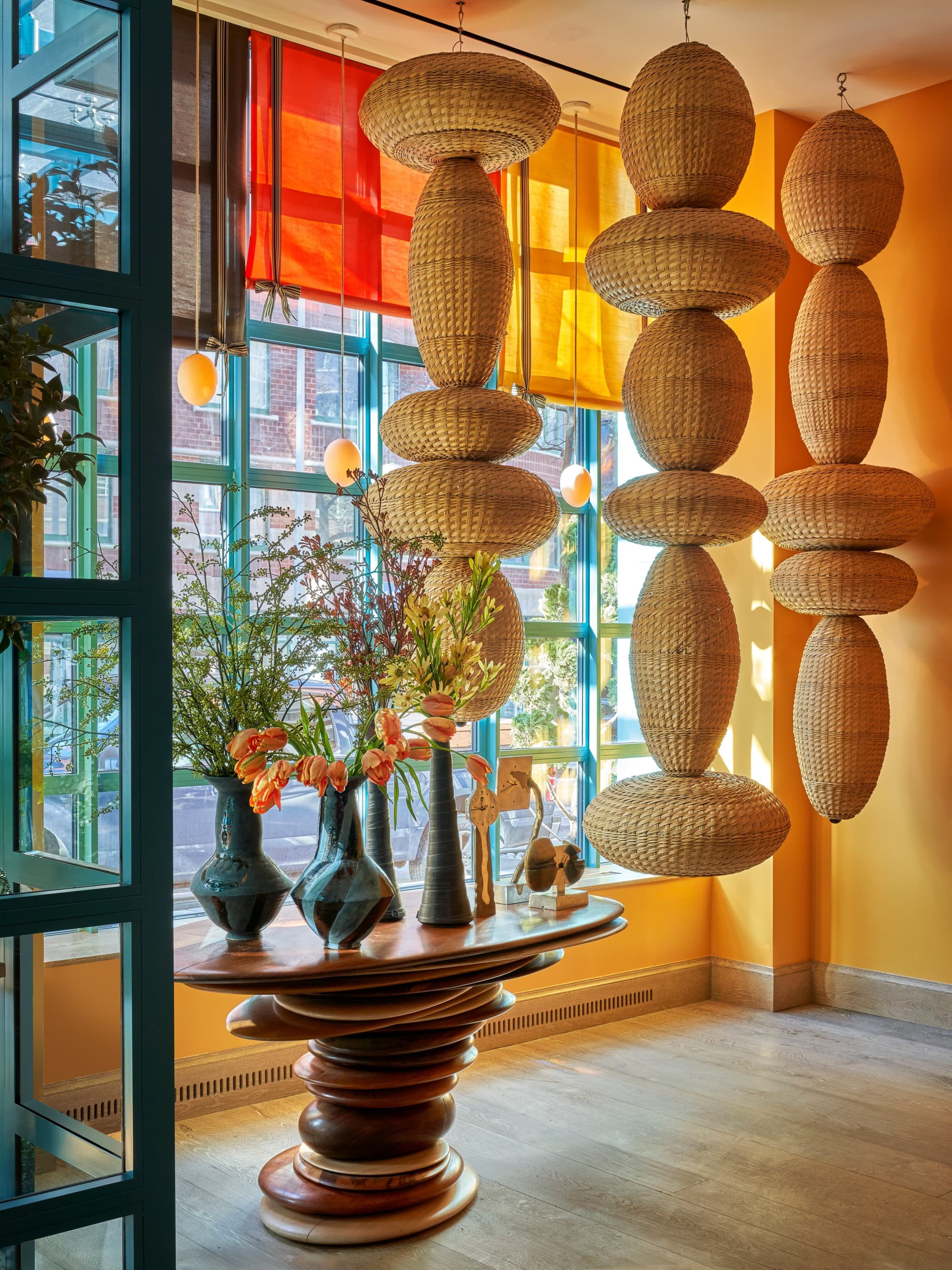 circular sculptures hang from the ceiling in a colorful entryway
