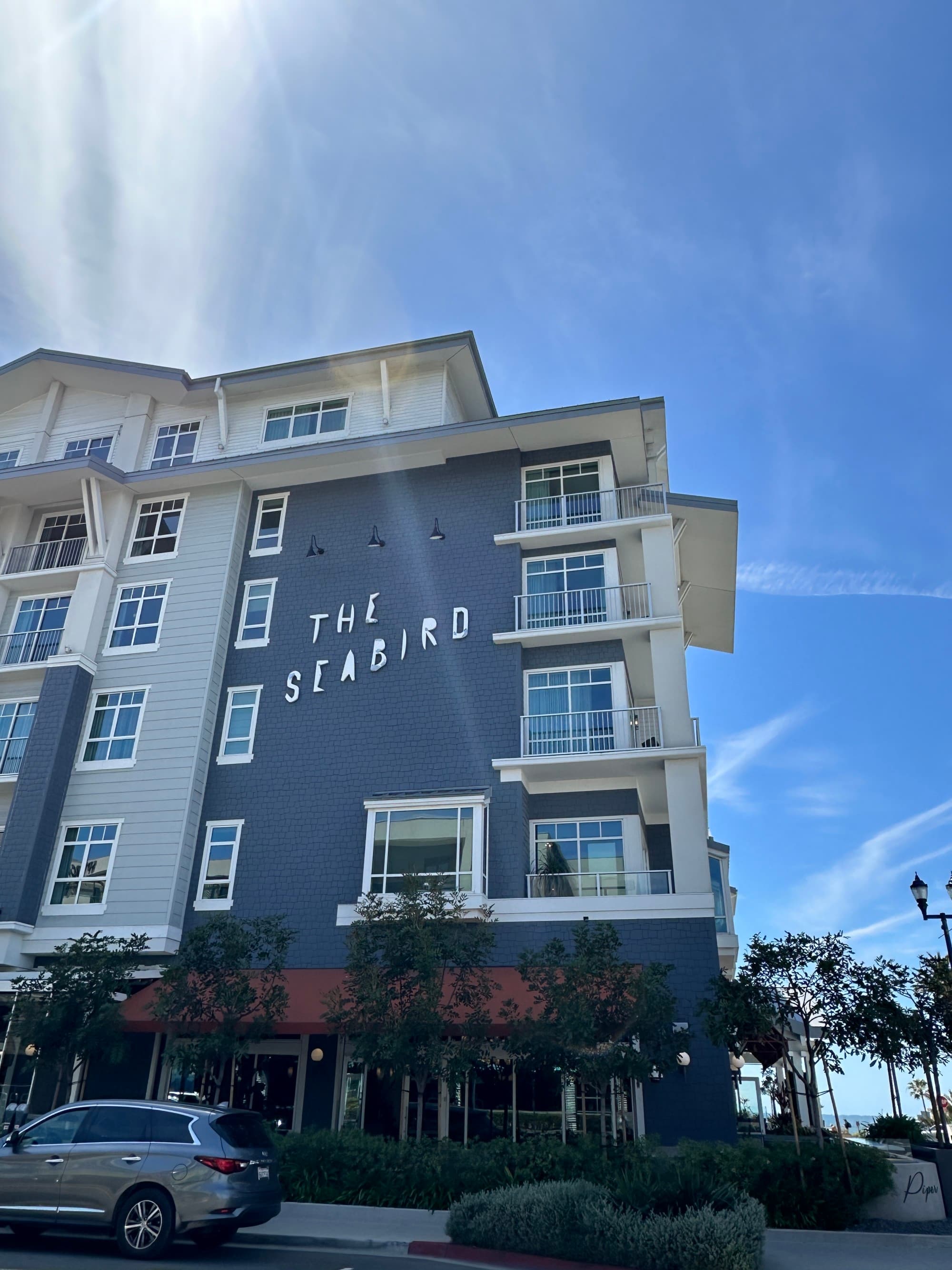 The outside of the hotel with a sign reading "The Seabird" on the building
