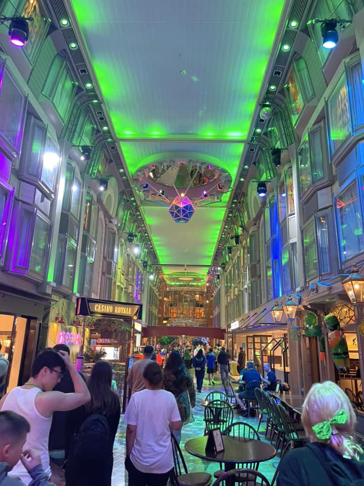 A view of a colorfully-lit hall on a cruise ship