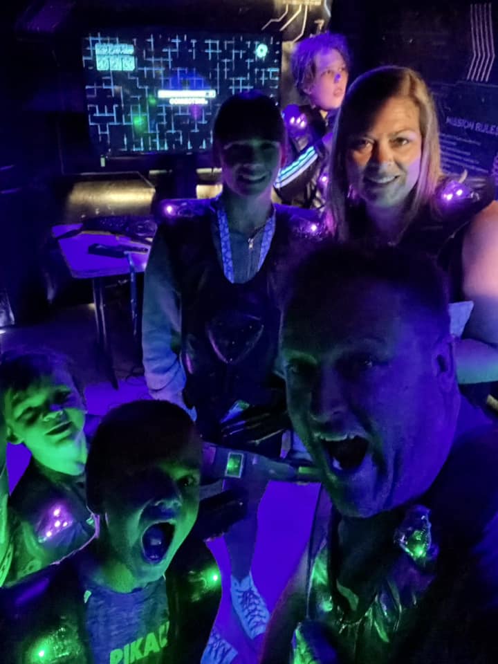A family posing for a selfie photo in a dark room