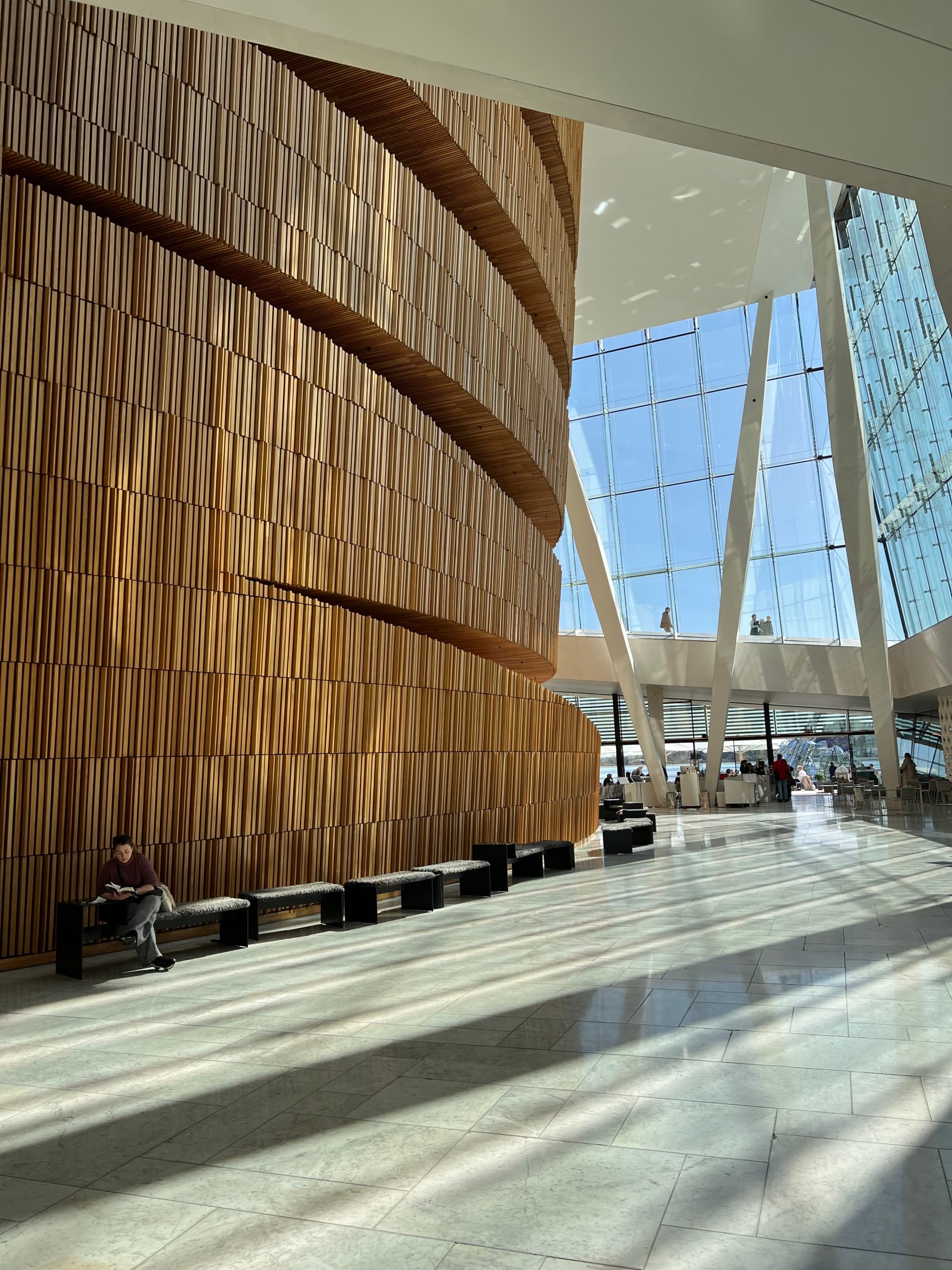 The inside of a building with tall ceilings with large windows