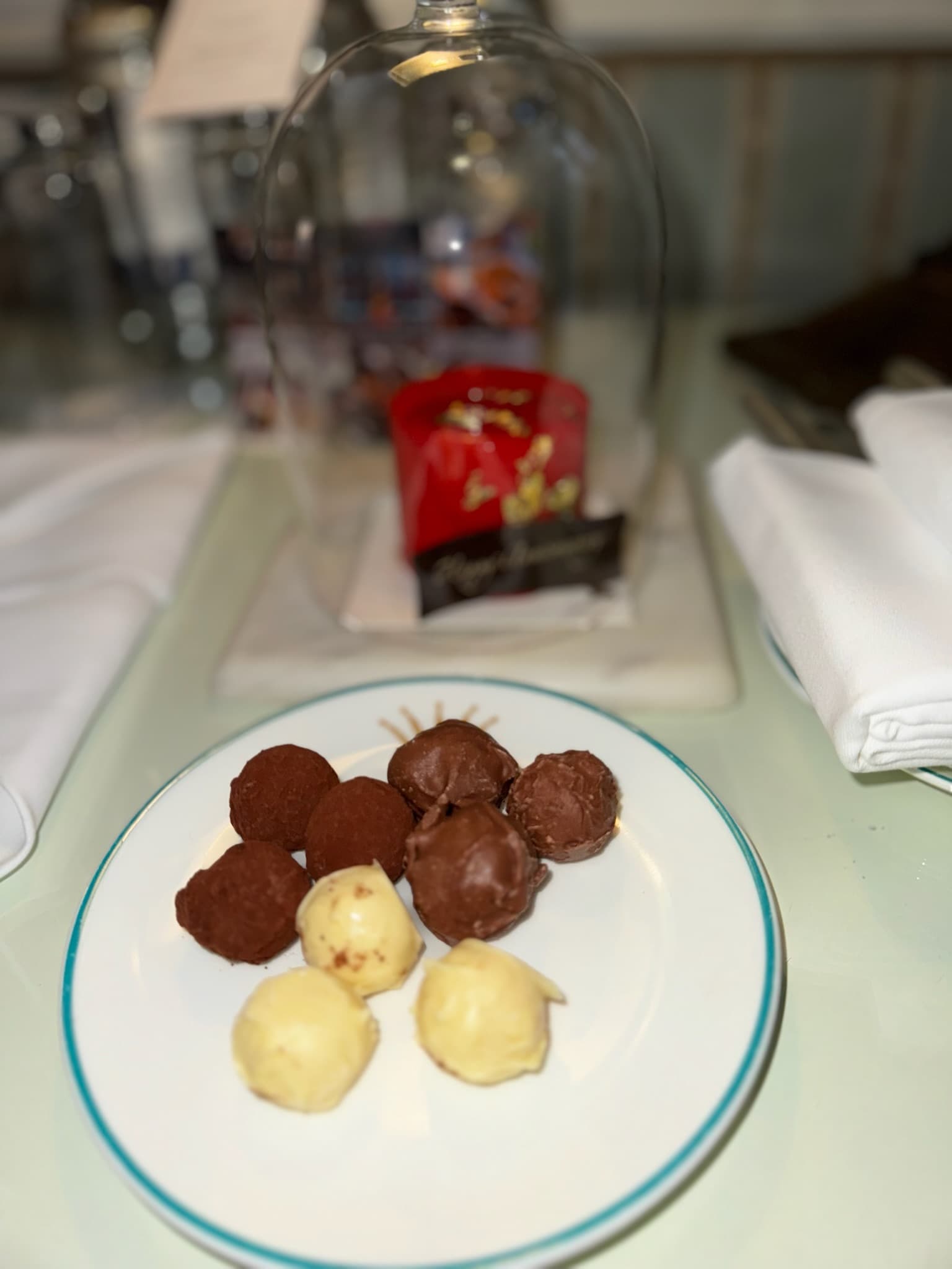 A plate of white and milk chocolate truffles.