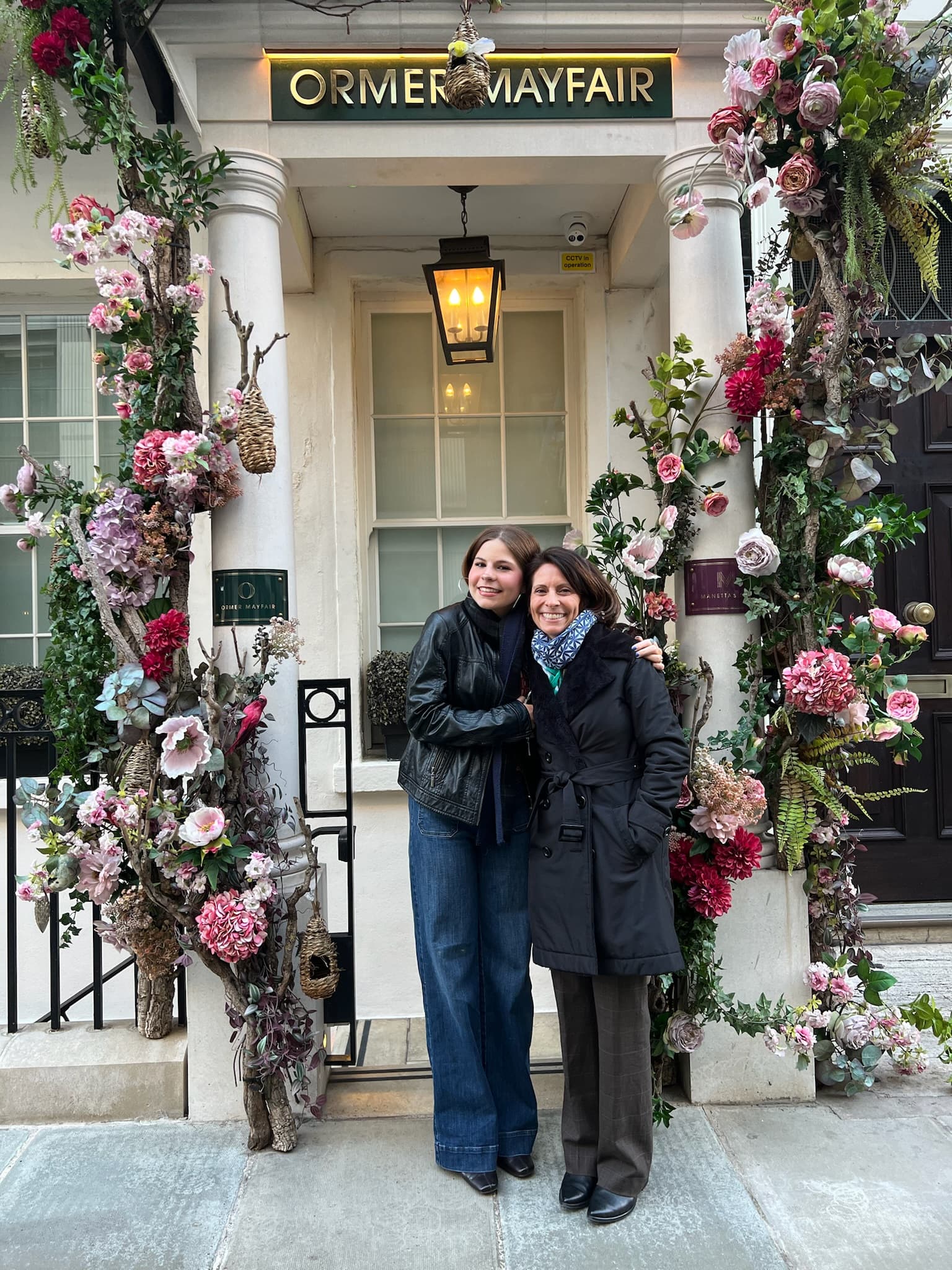 Sara and her sister standing in front of the entrance to the Flemings Mayfair Michelin Star Restaurant Ormer.