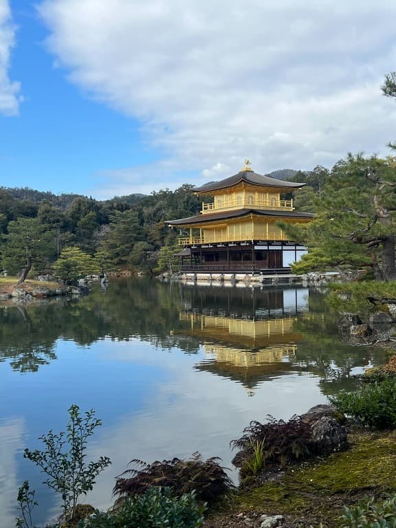 Kyoto Gold Shrine, a yellow building next to a pond, in December in Japan.