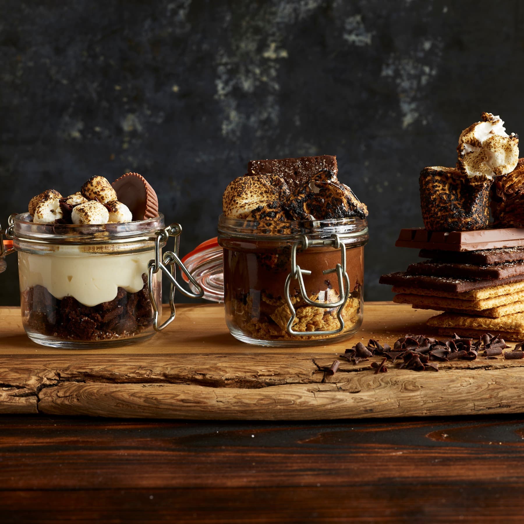a close-up of glass jars filled with chocolate, candy and marshmallows