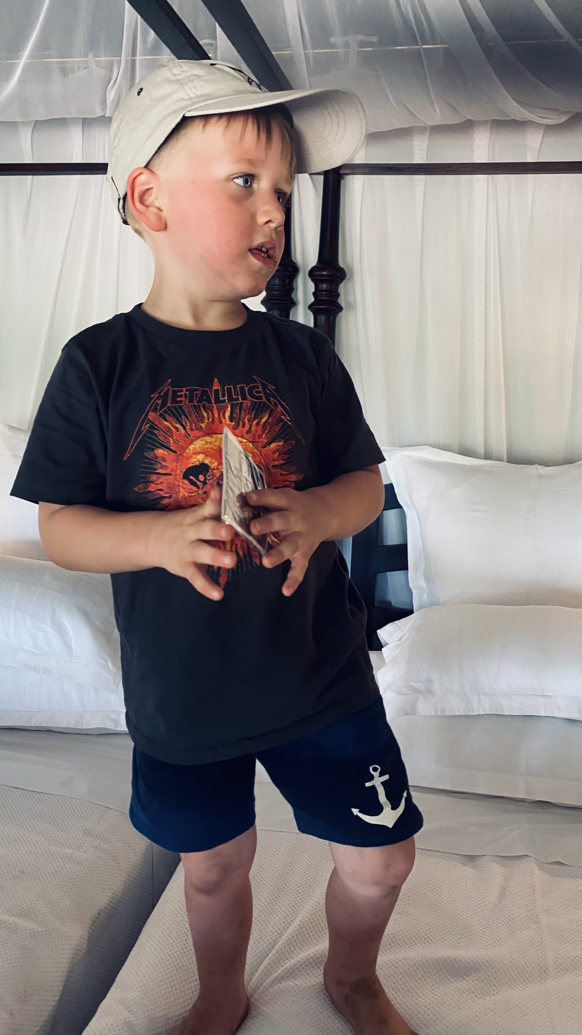 Child in black tshirt and cap