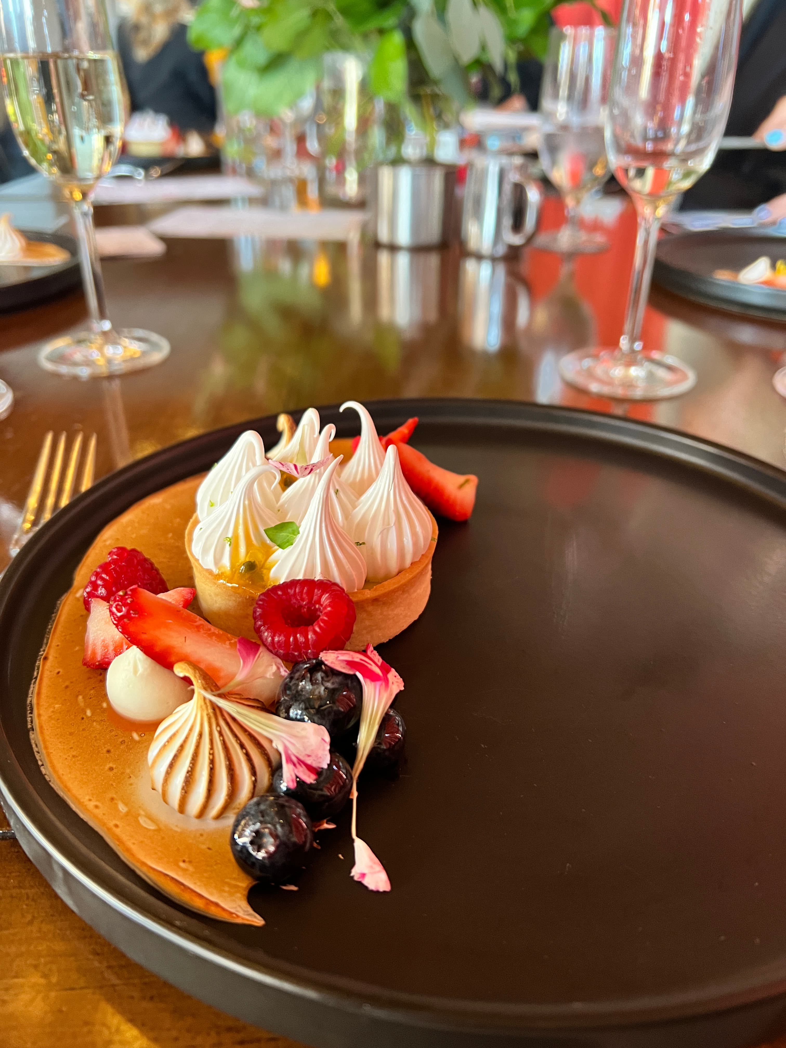 Delicious dessert served on a dark plate at the Four Seasons Resort