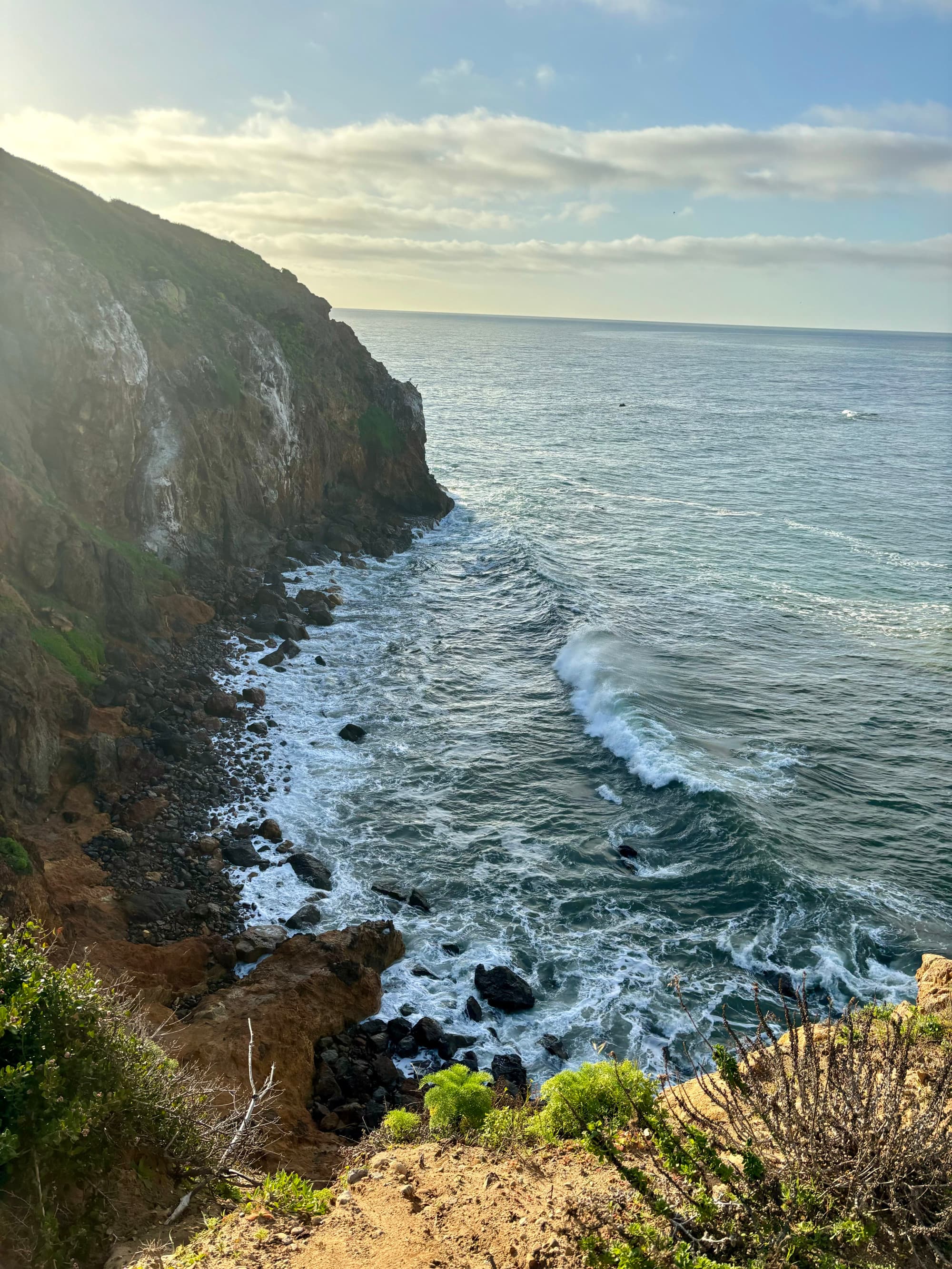 A view of waves crashing along the rocky shore in Malibu.