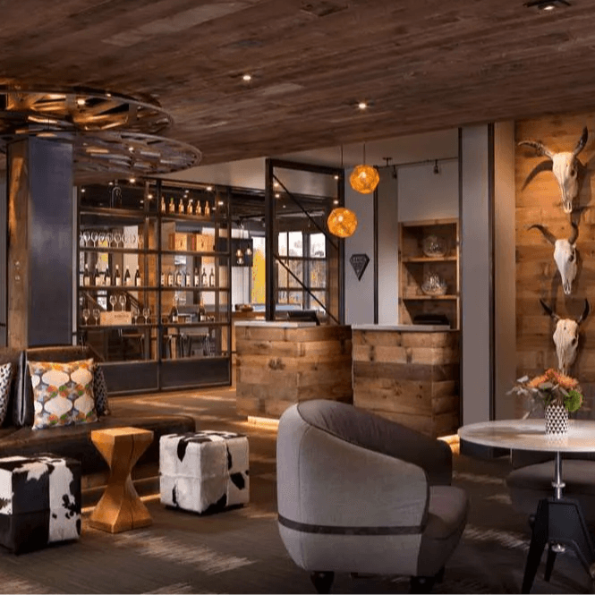 a dimly lit hotel lobby with animal skulls hanging on a wooden wall