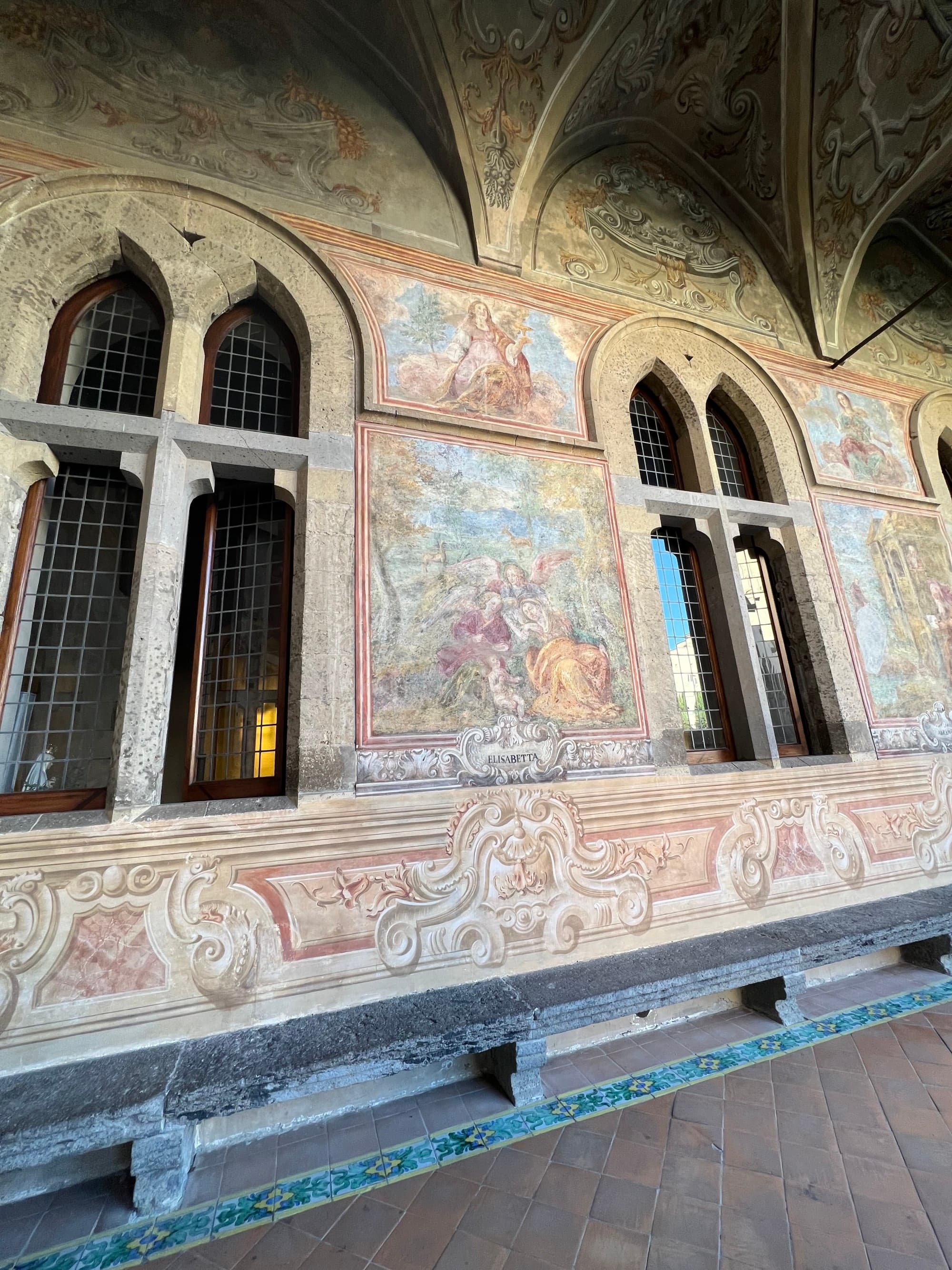 A painted wall with medieval-style arched windows