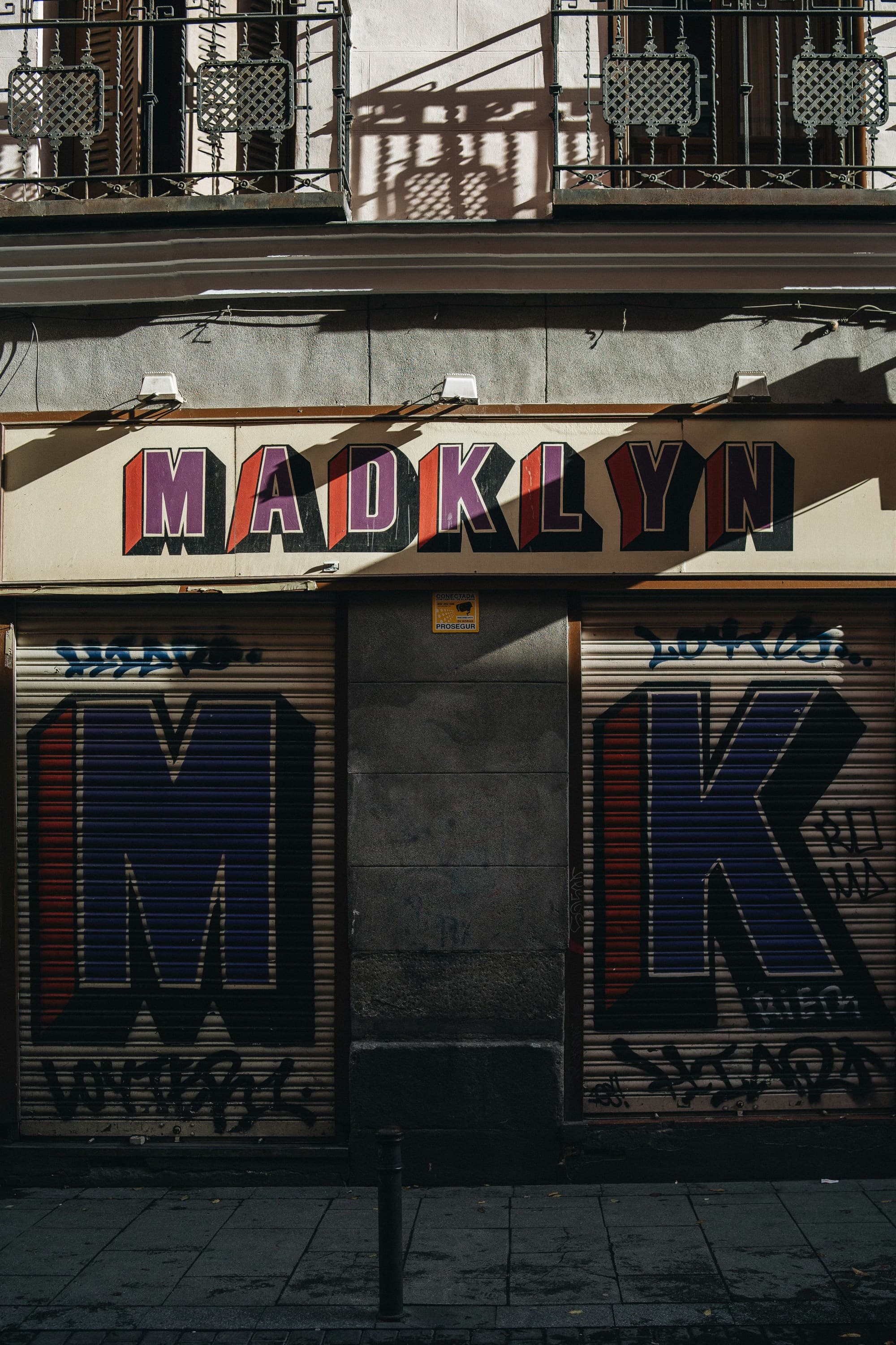 an urban garage façade that reads "Madklyn"