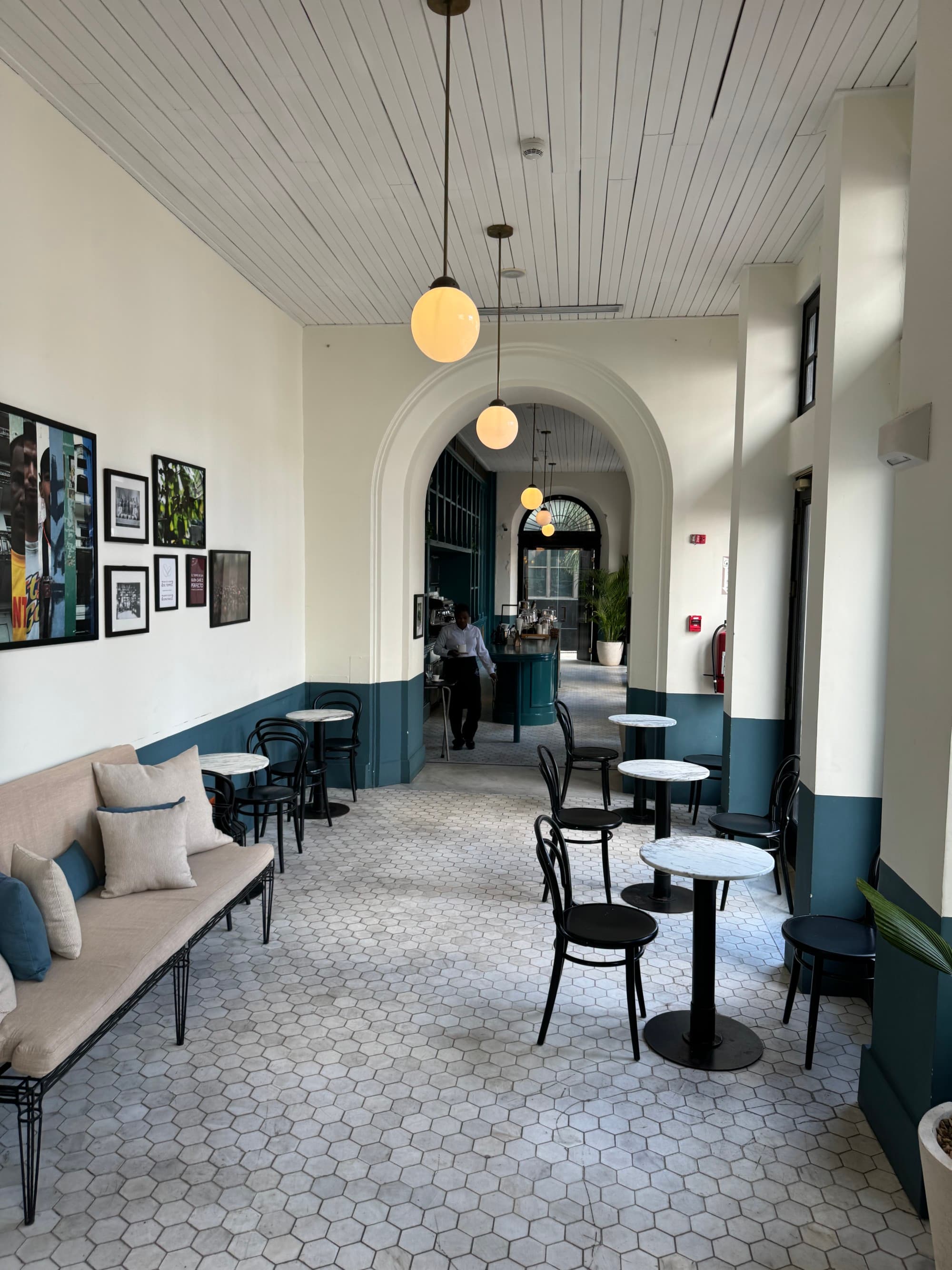 Inside sitting area with opulent lighting and large windows.