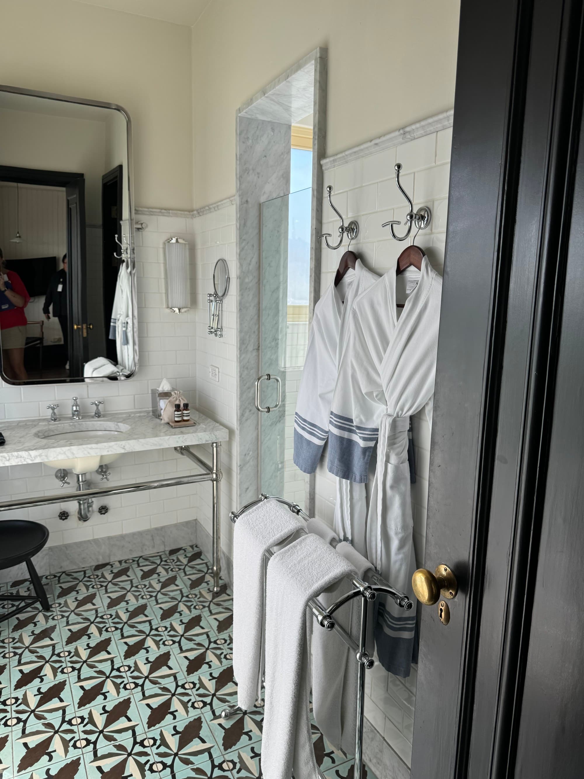 Hotel bathroom with a lovely tile floor and a spacious vanity.