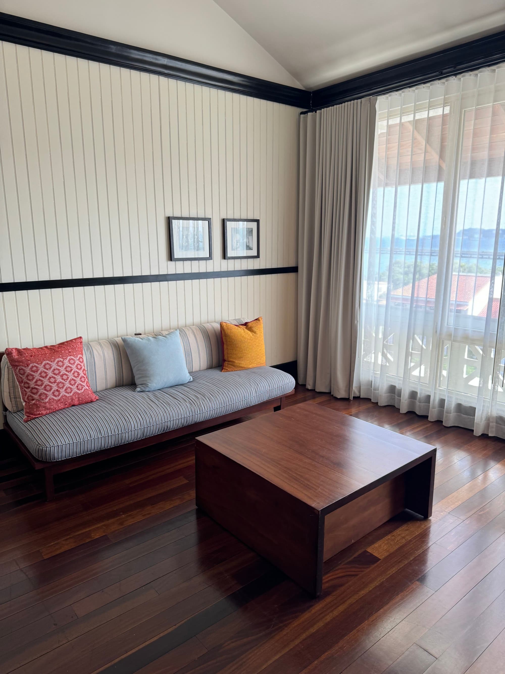 Sitting Area with large windows and lovely sheer curtains.