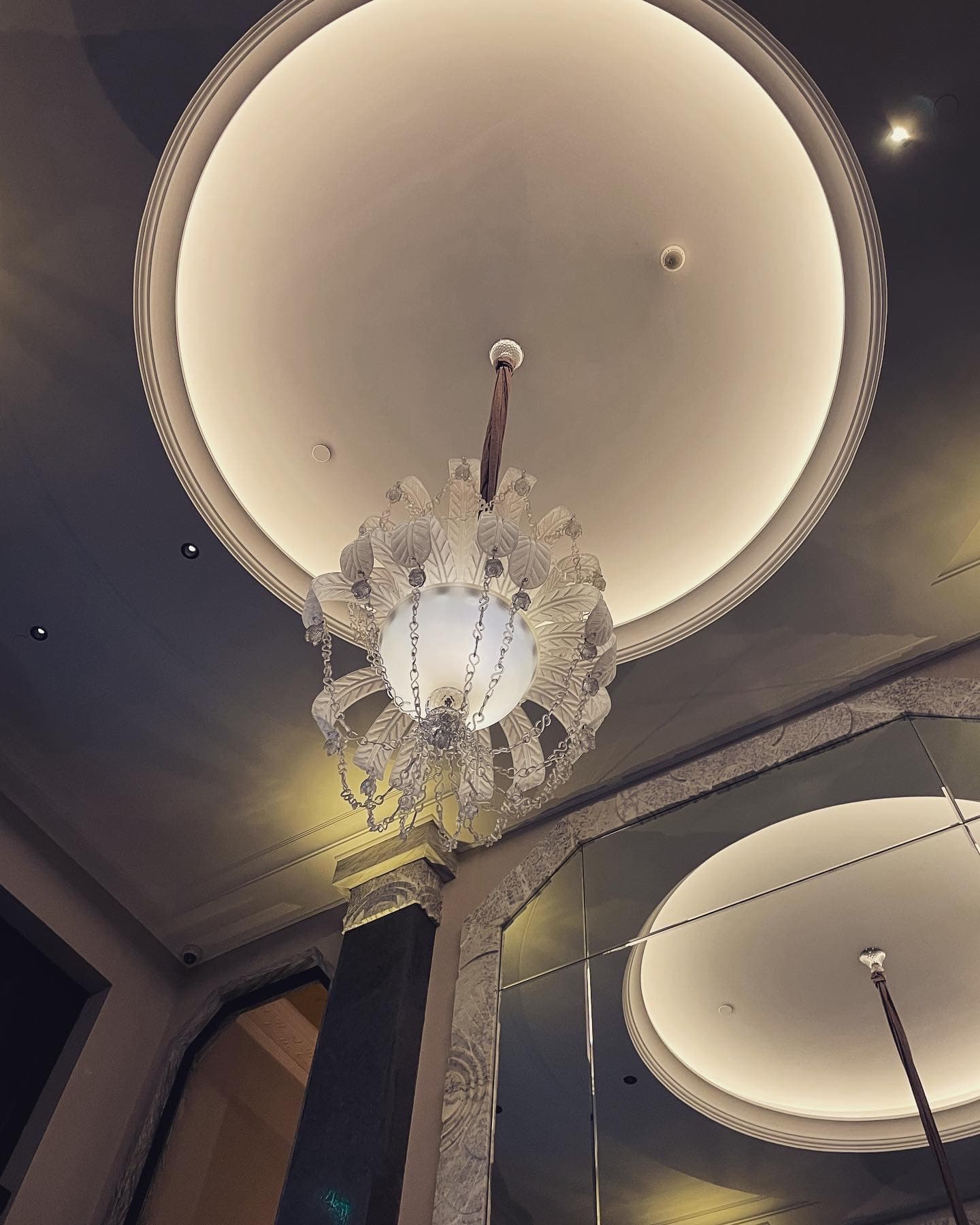 White chandelier on the ceiling of a building