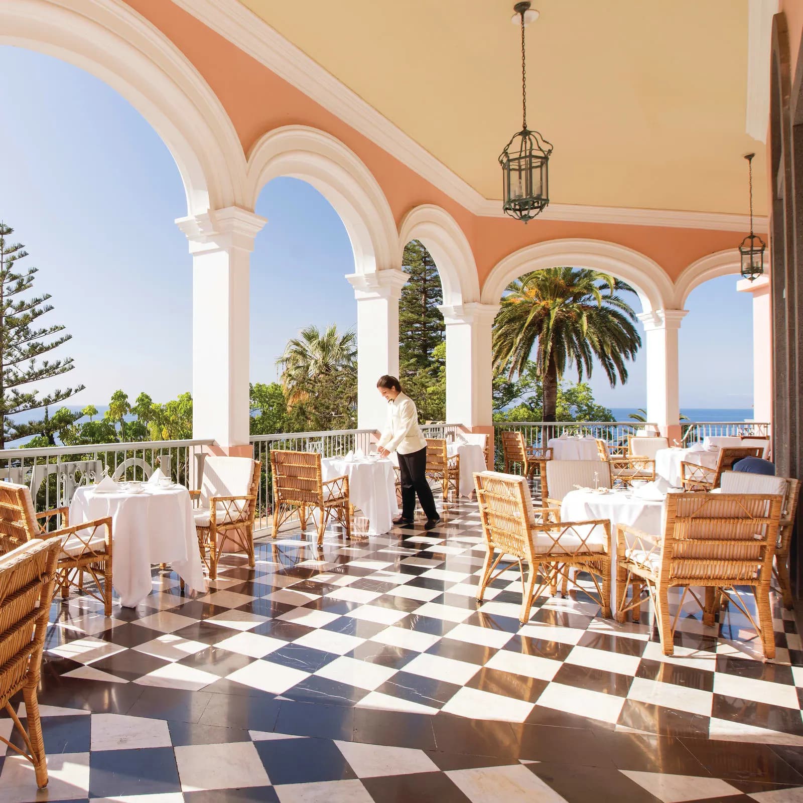a sunny terrace with black-and-white checkered tiling