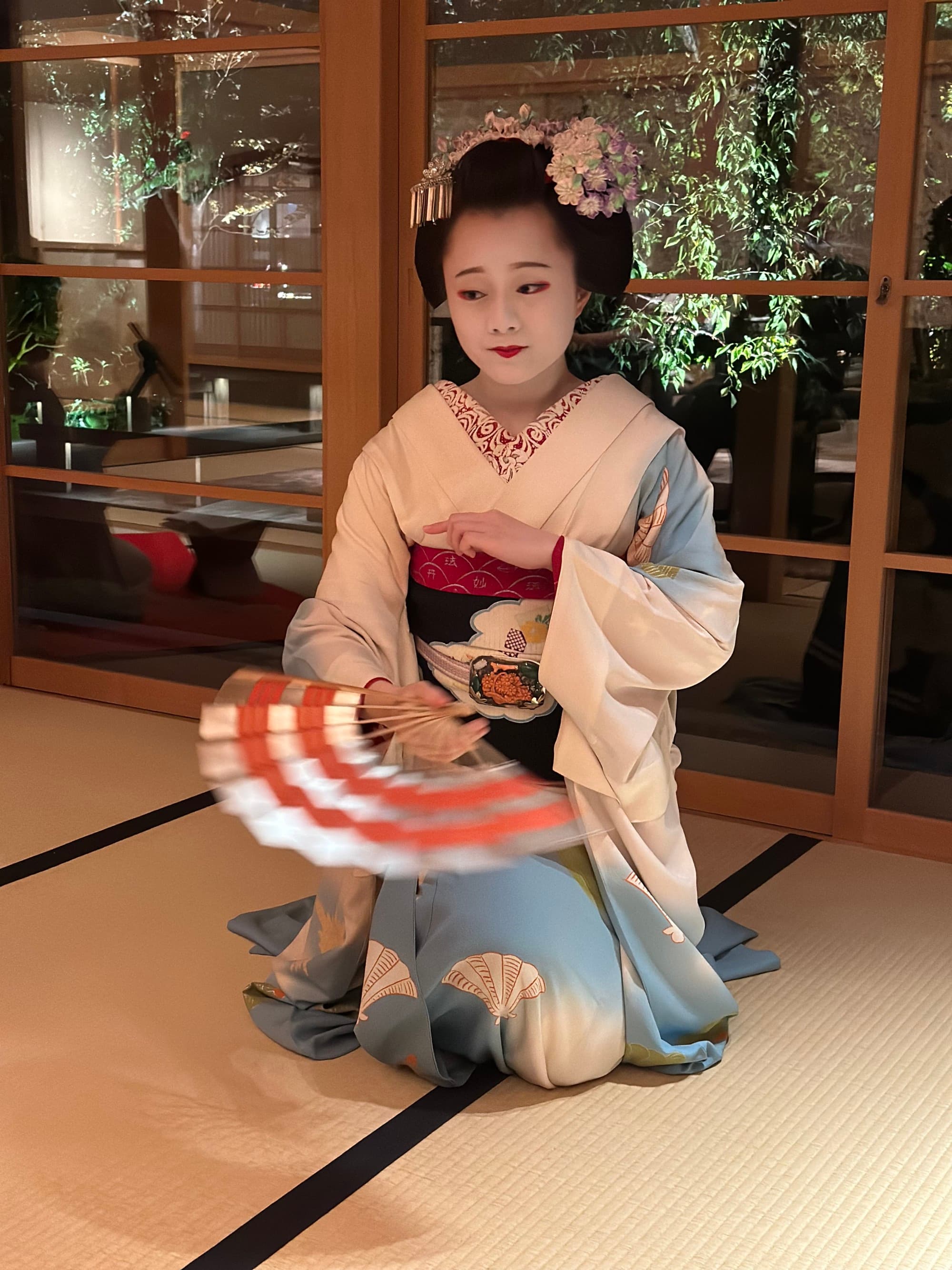 A female holding a decoration hand fan