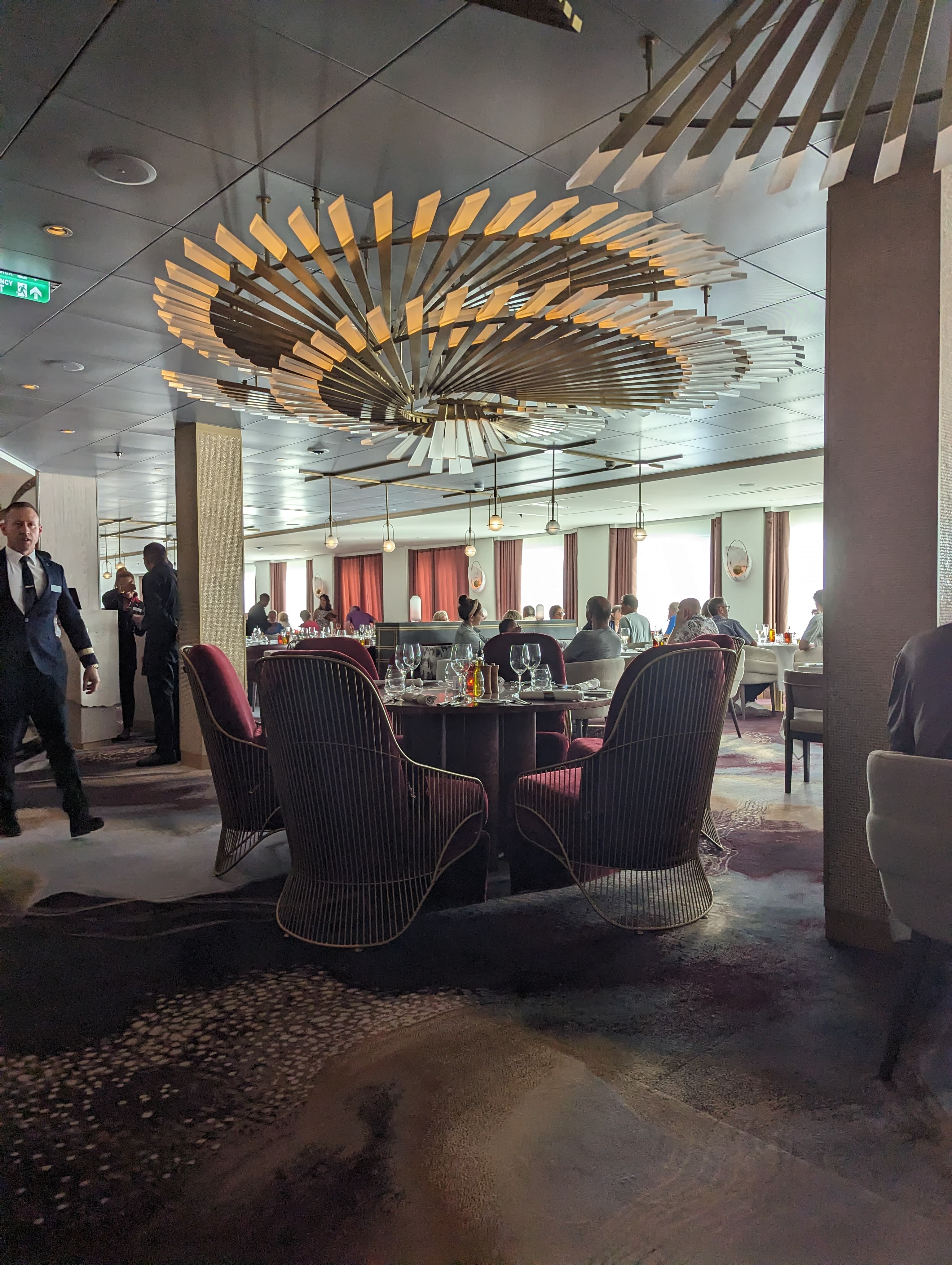 A restaurant on the ship with tables and chairs