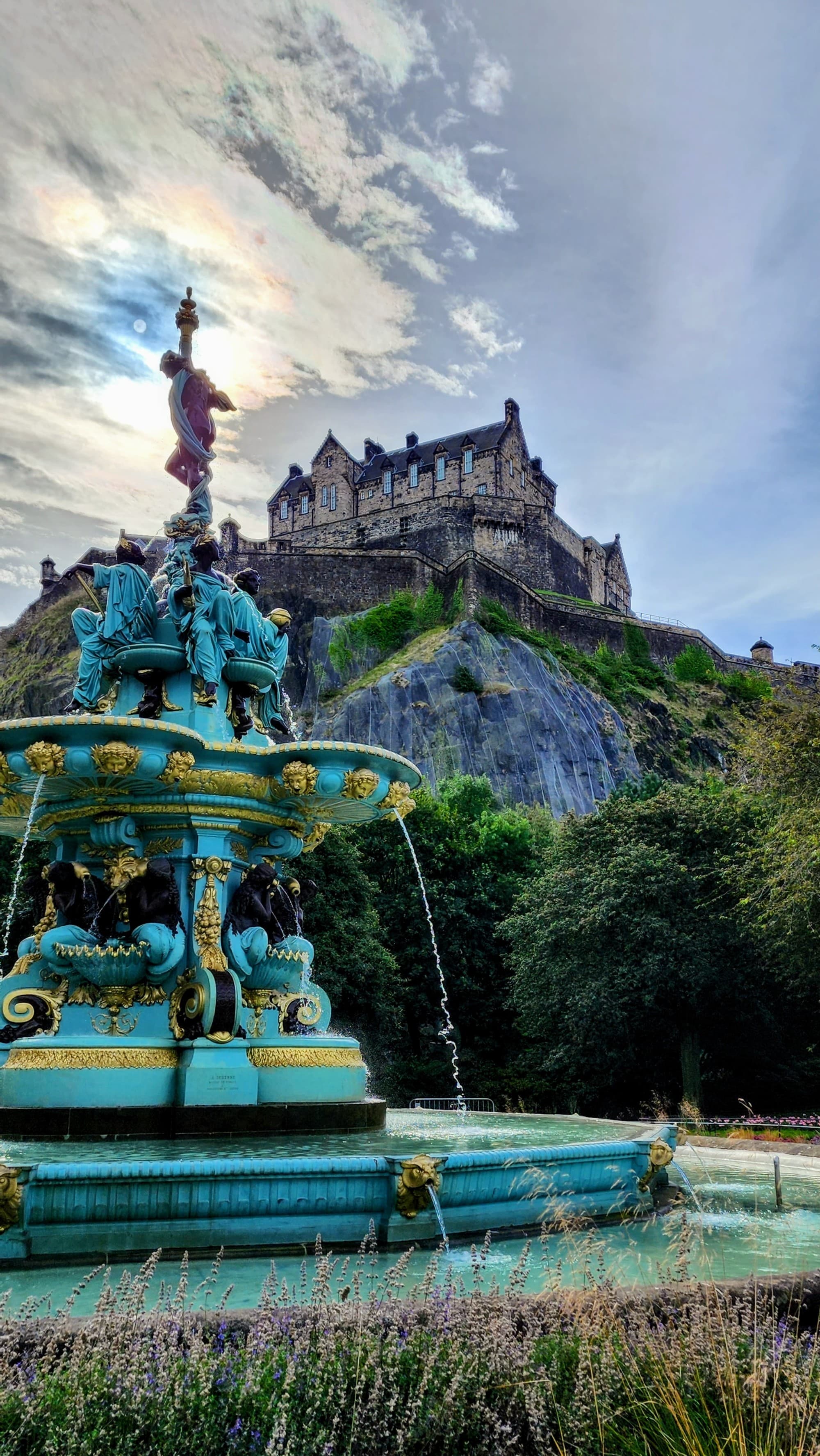 Keeping watch of the city, Edinburgh Castle looks regal from the fountain at Princes St Gardens