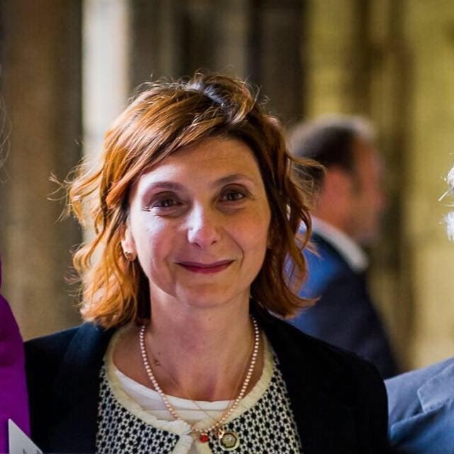 a headshot of a beautiful woman with short brown hair