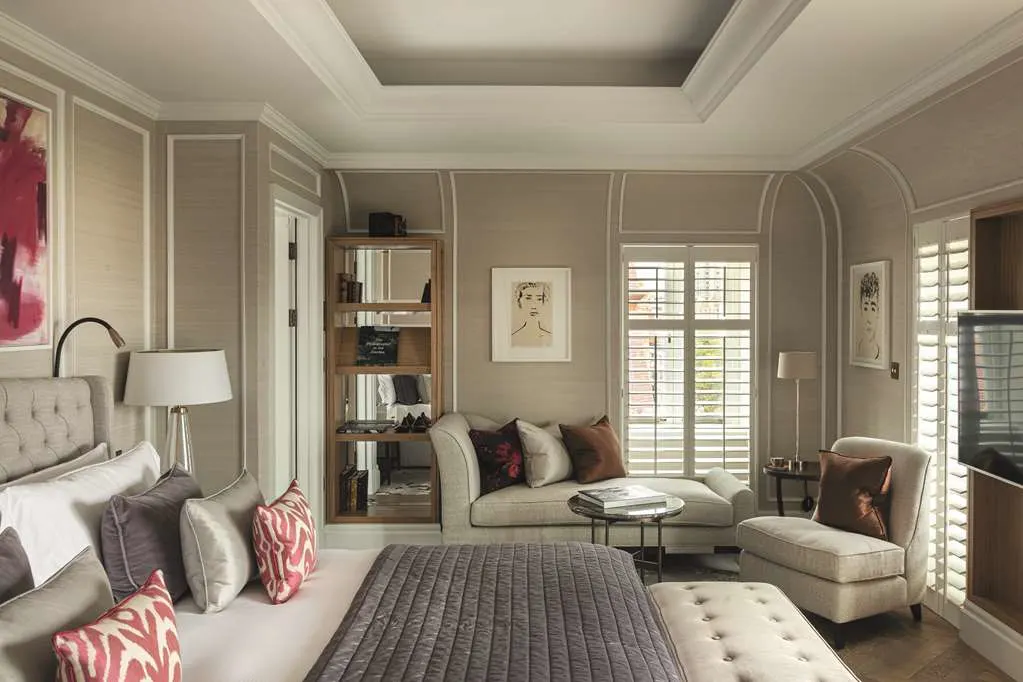 a posh hotel room with cream and pin decor