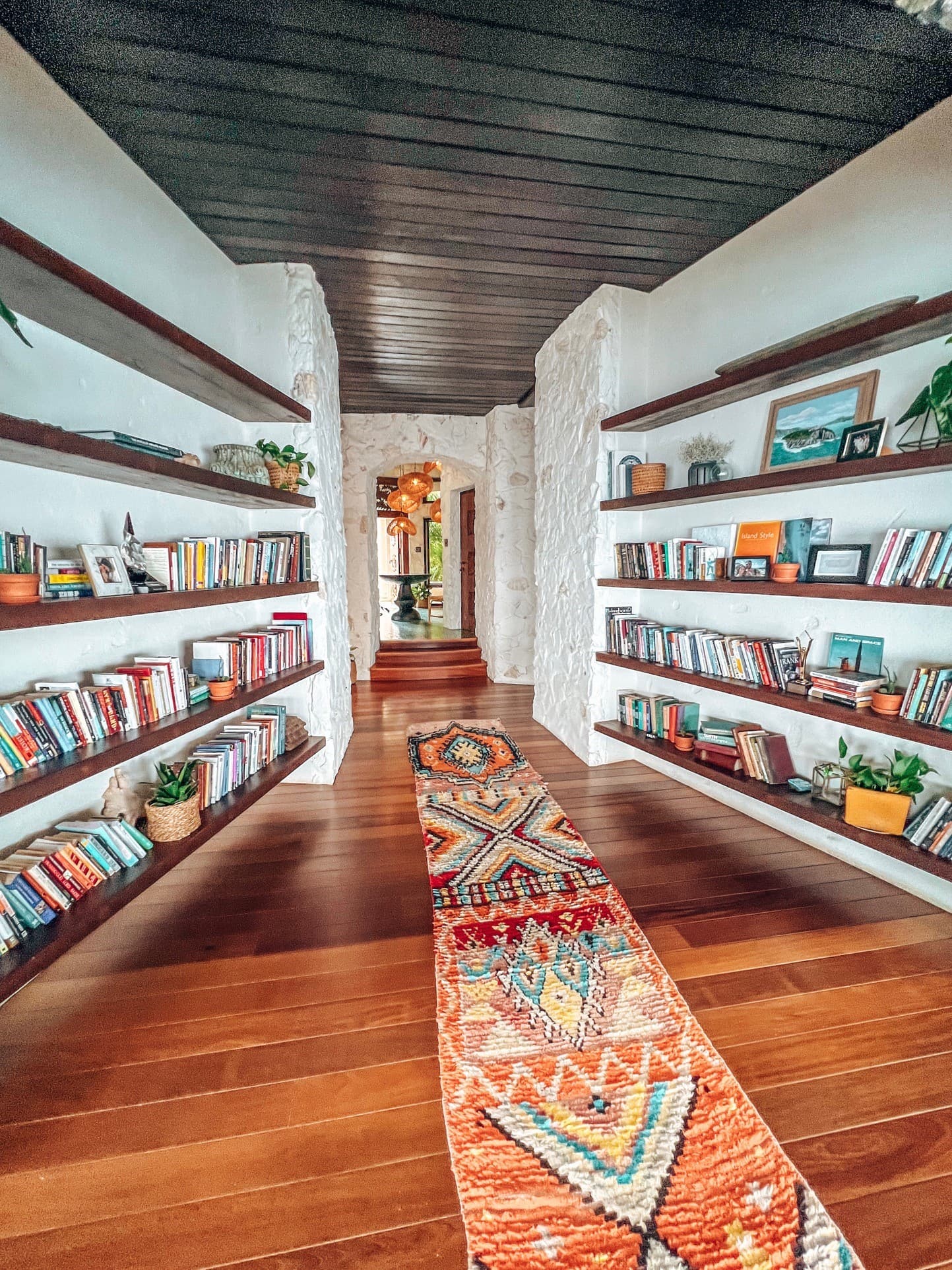 A library room with a colorful rug running through it
