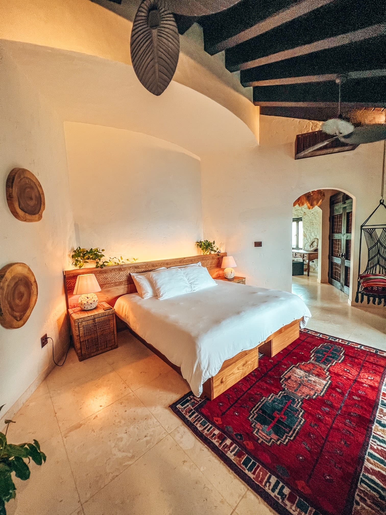 A hotel room with a red rug on the floor