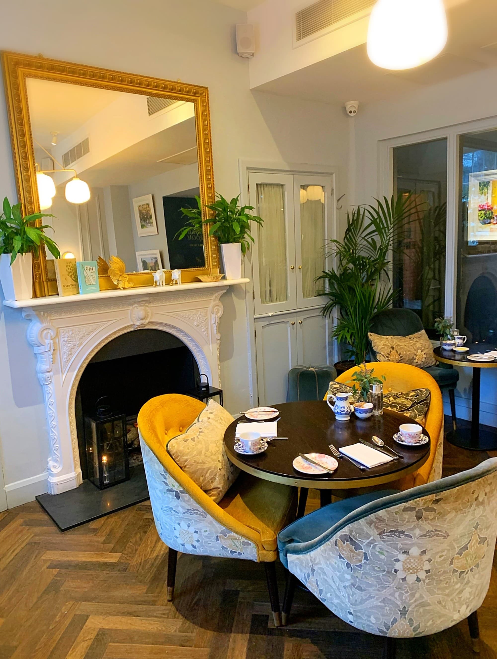 A dining area in a hotel with three chairs around a round table