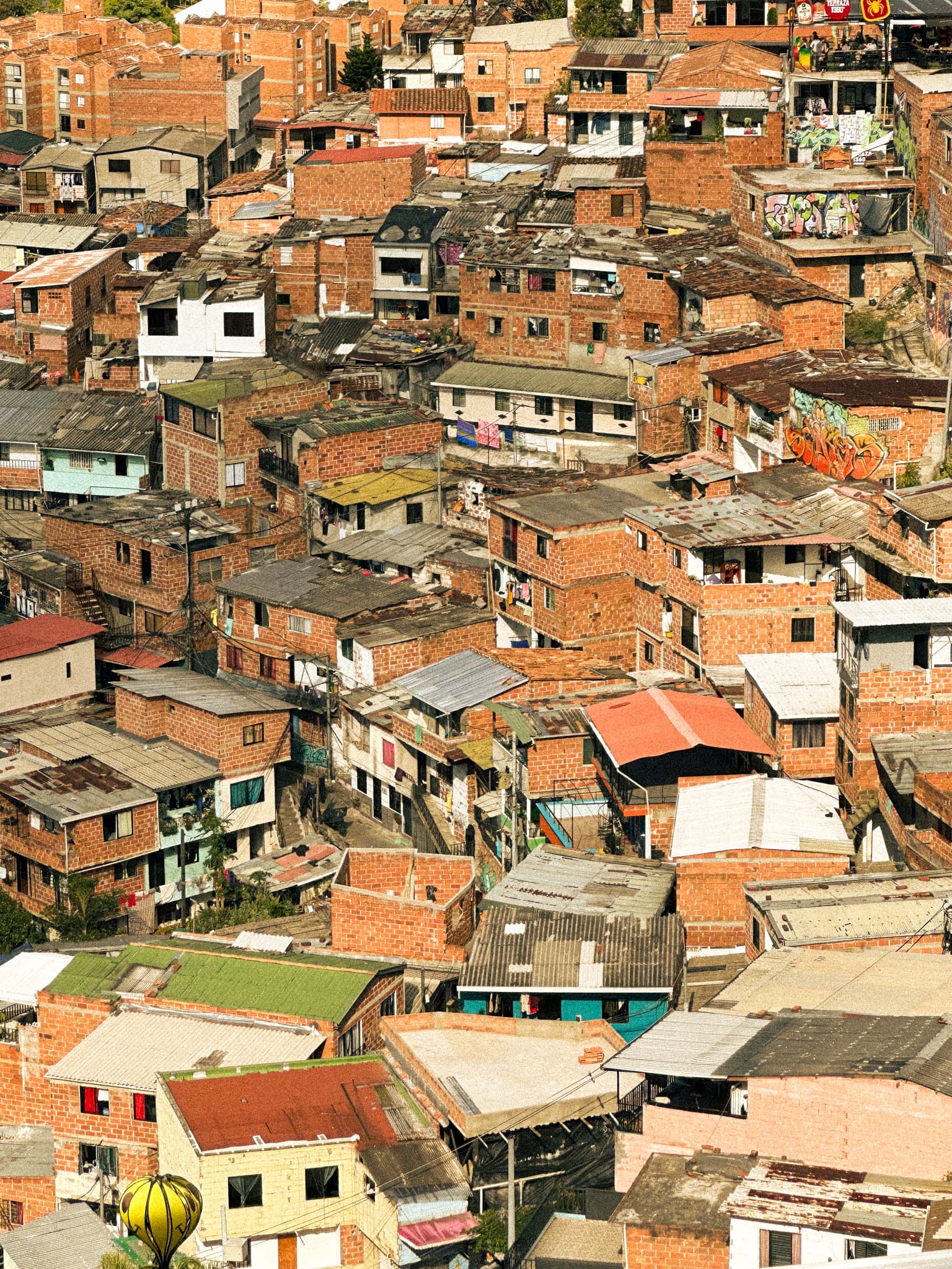A view of city buildings clustered together with red roofing.