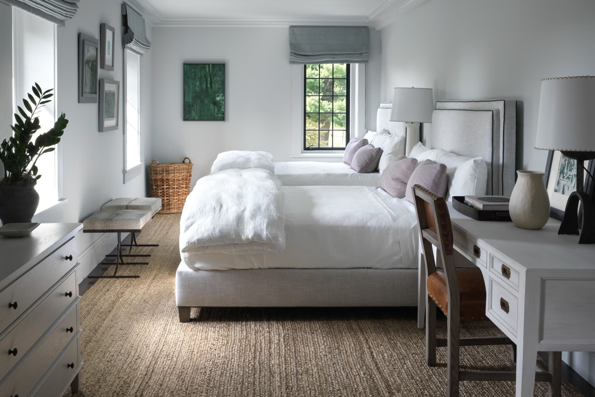 two white beds in a chic room with a tan rug