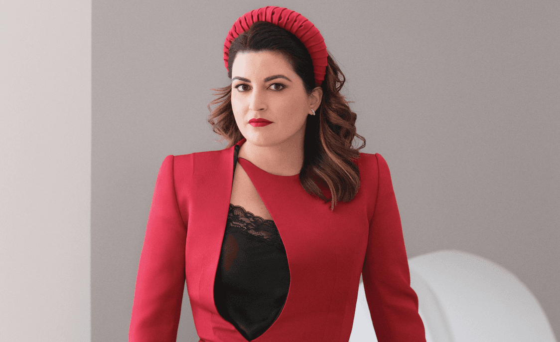 a woman in a black shirt and red jacket wars a red headband