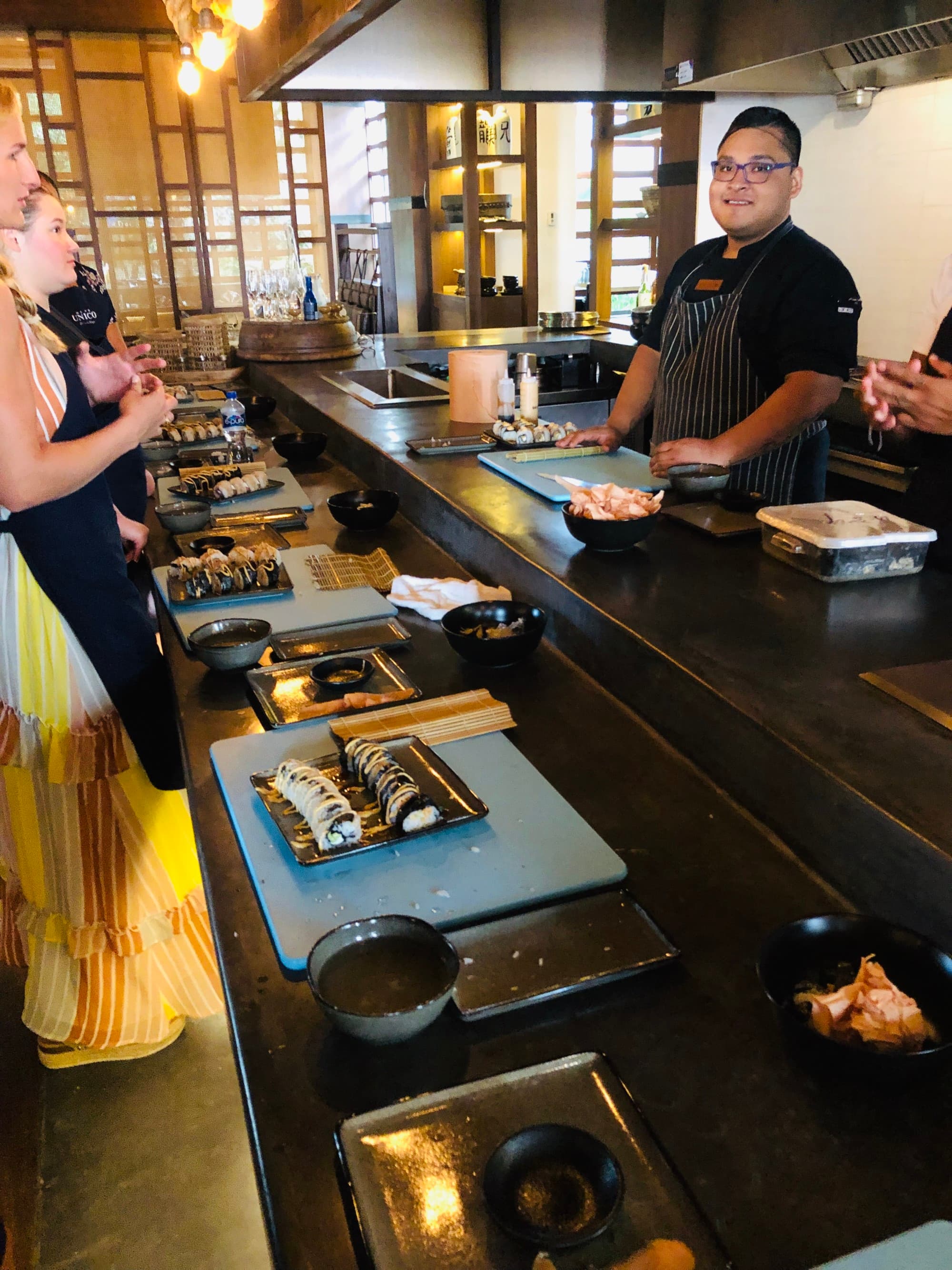 Chef preparing food with guests eagerly waiting