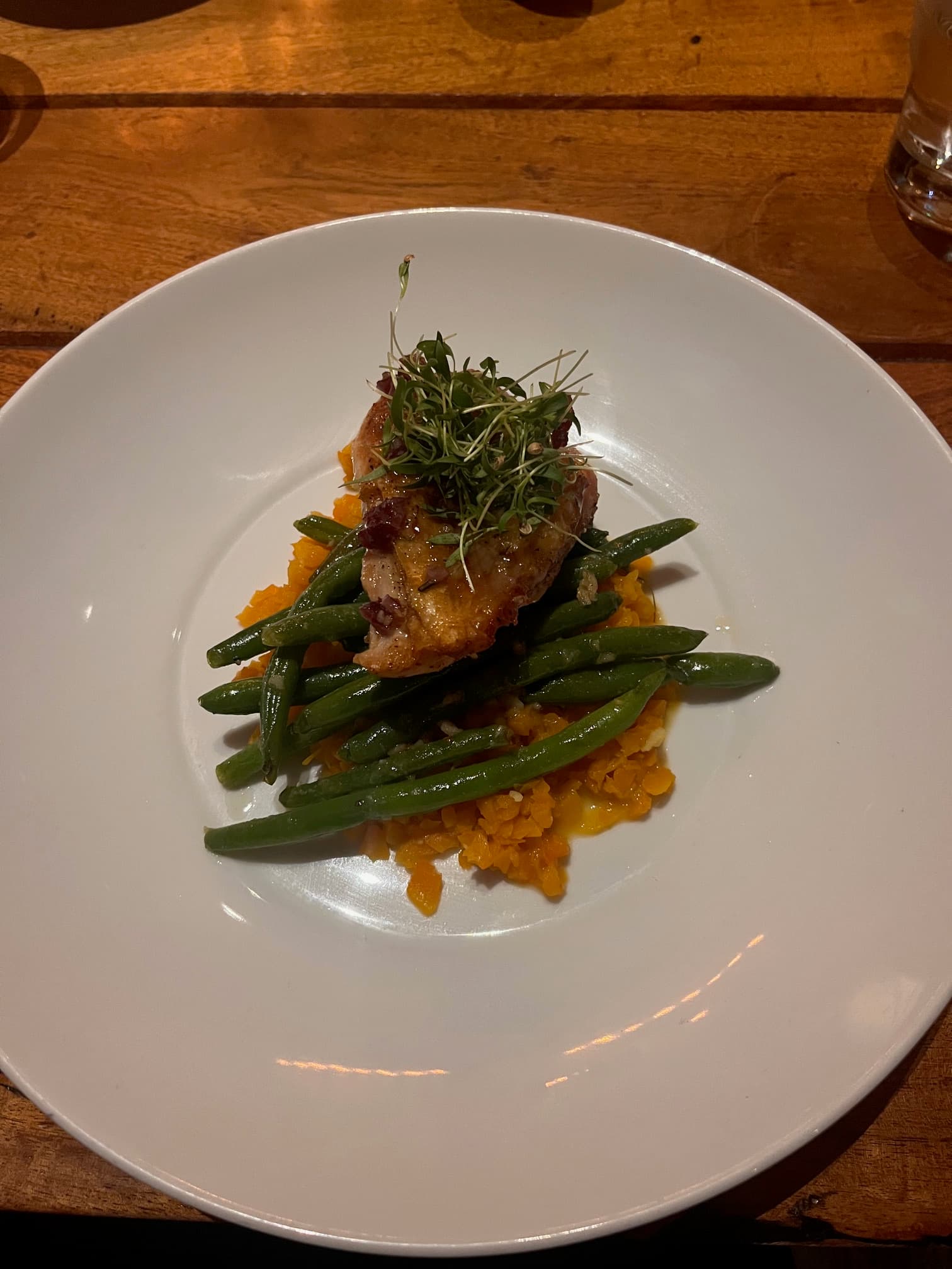 An aerial view of an elegant white plate with gourmet food at the restaurant Kosin