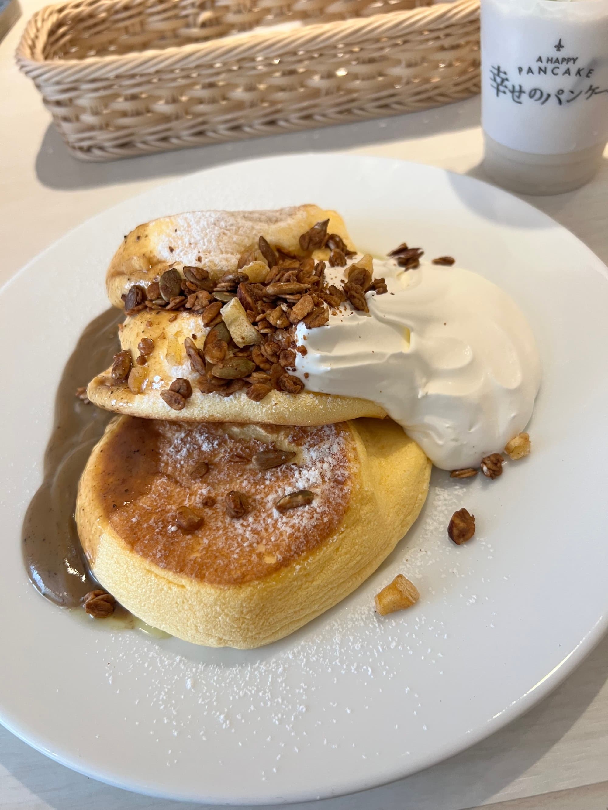 Two pancakes with cream on a white plate