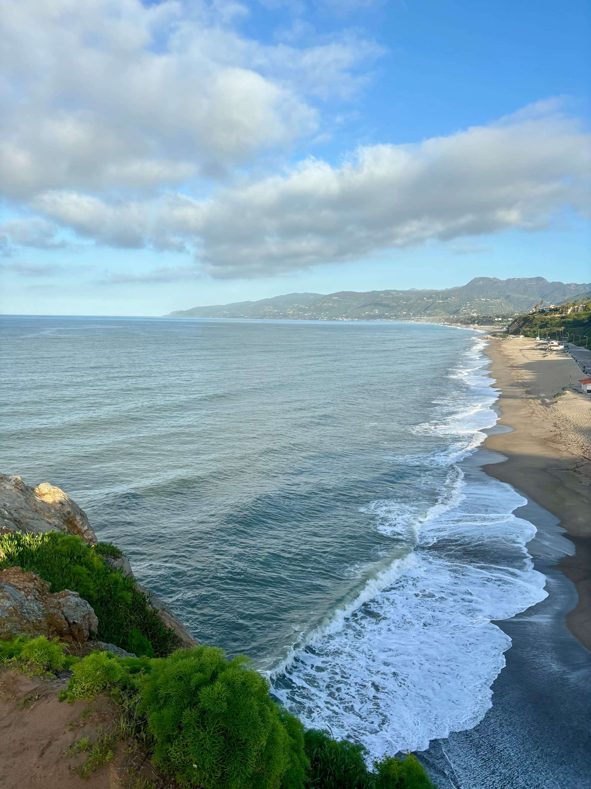 A view of the waves rolling in on the coastal shoreline of Malibu.
