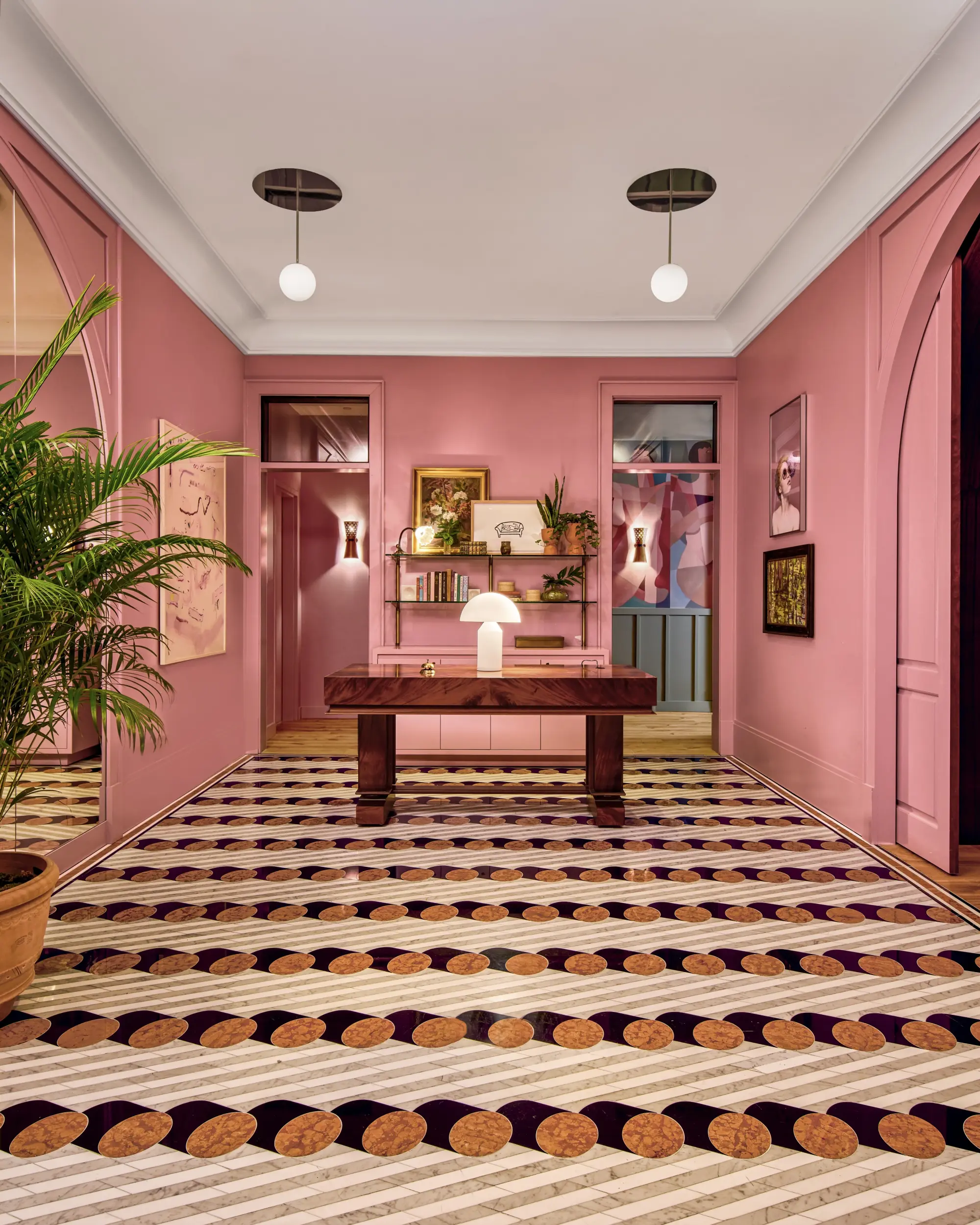 a vibrant pink lobby with patterned carpet