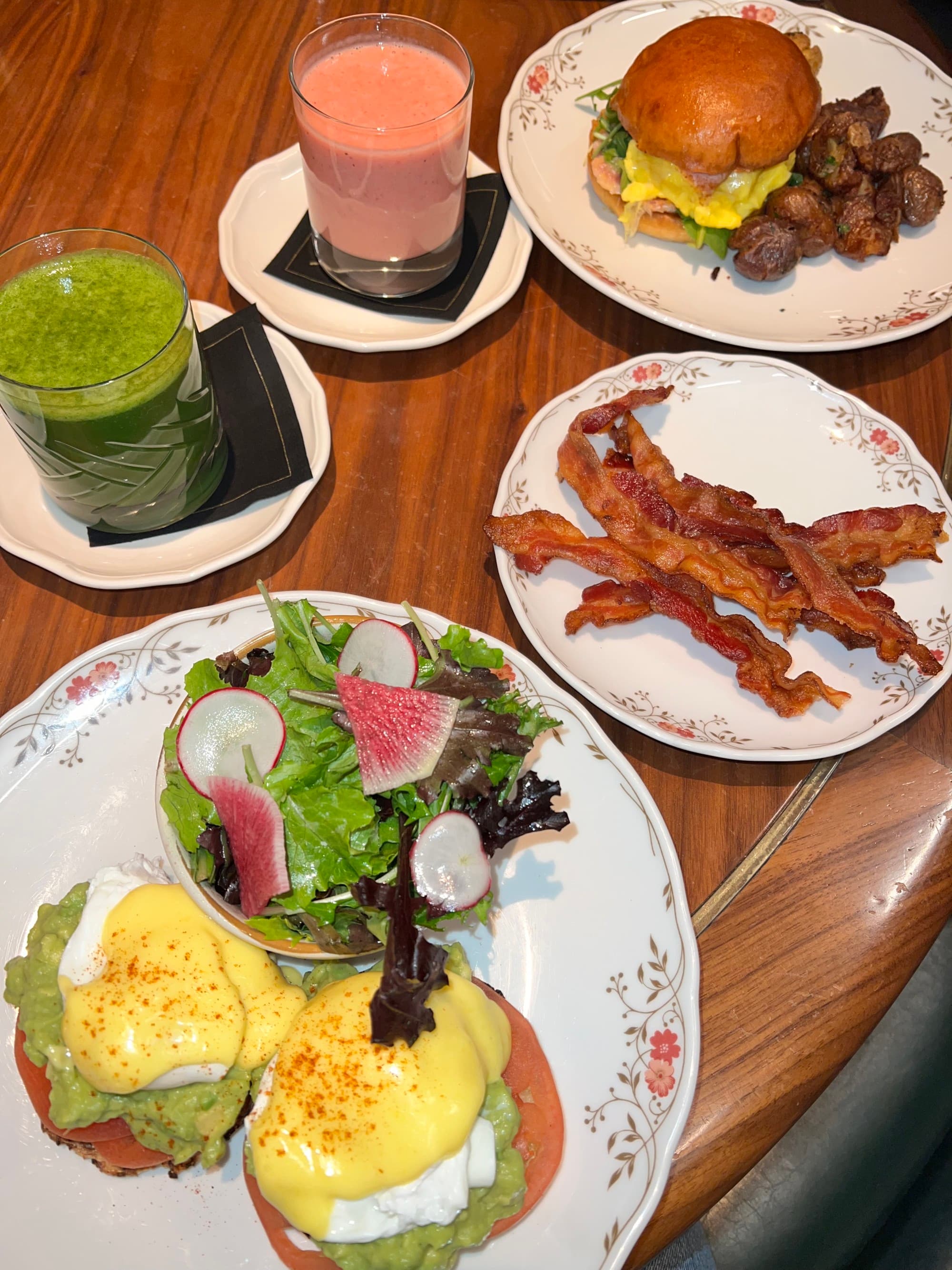An aerial view of a cooked breakfast on a table with smoothies