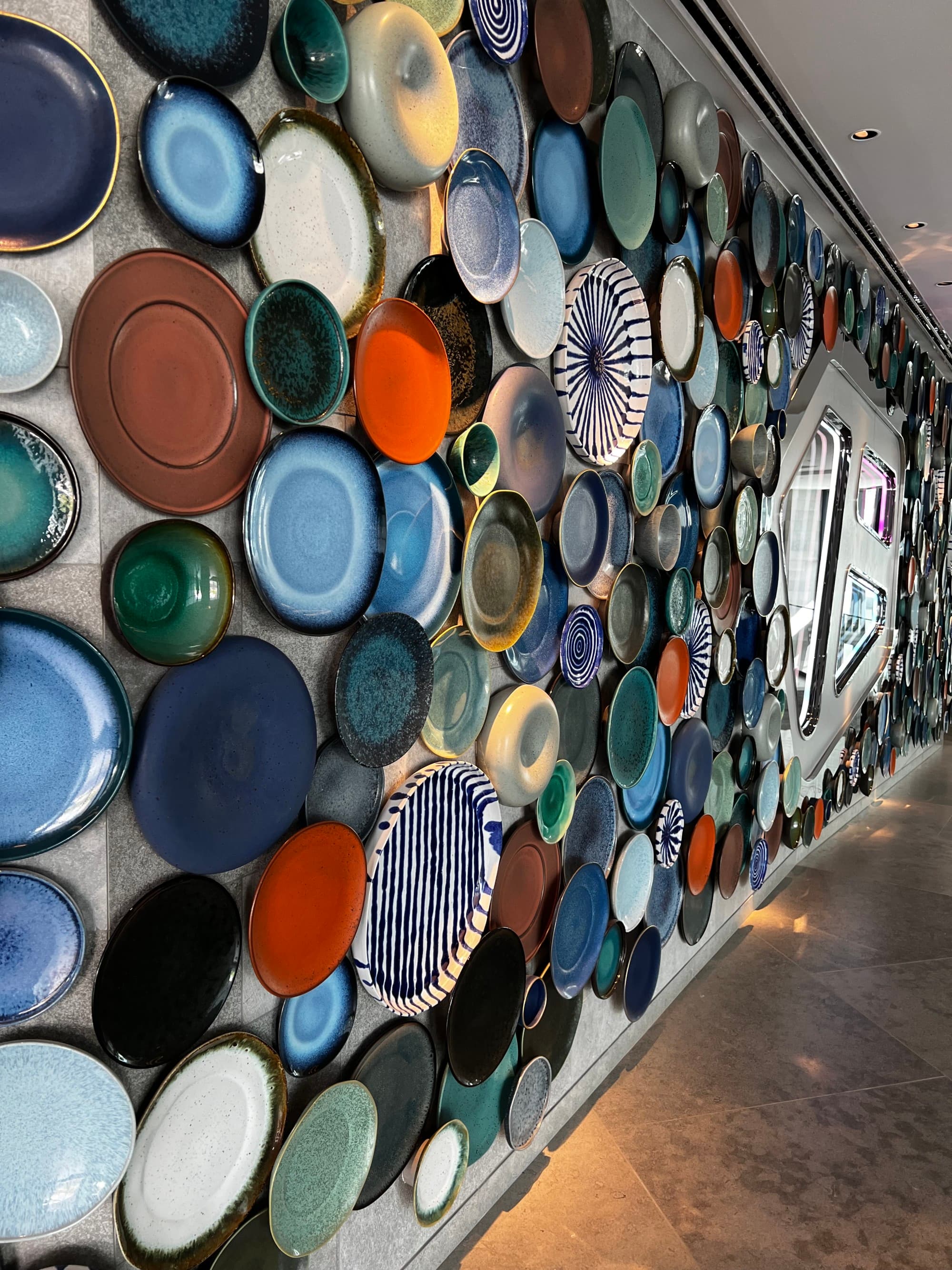 A wall hung with colorful pottery