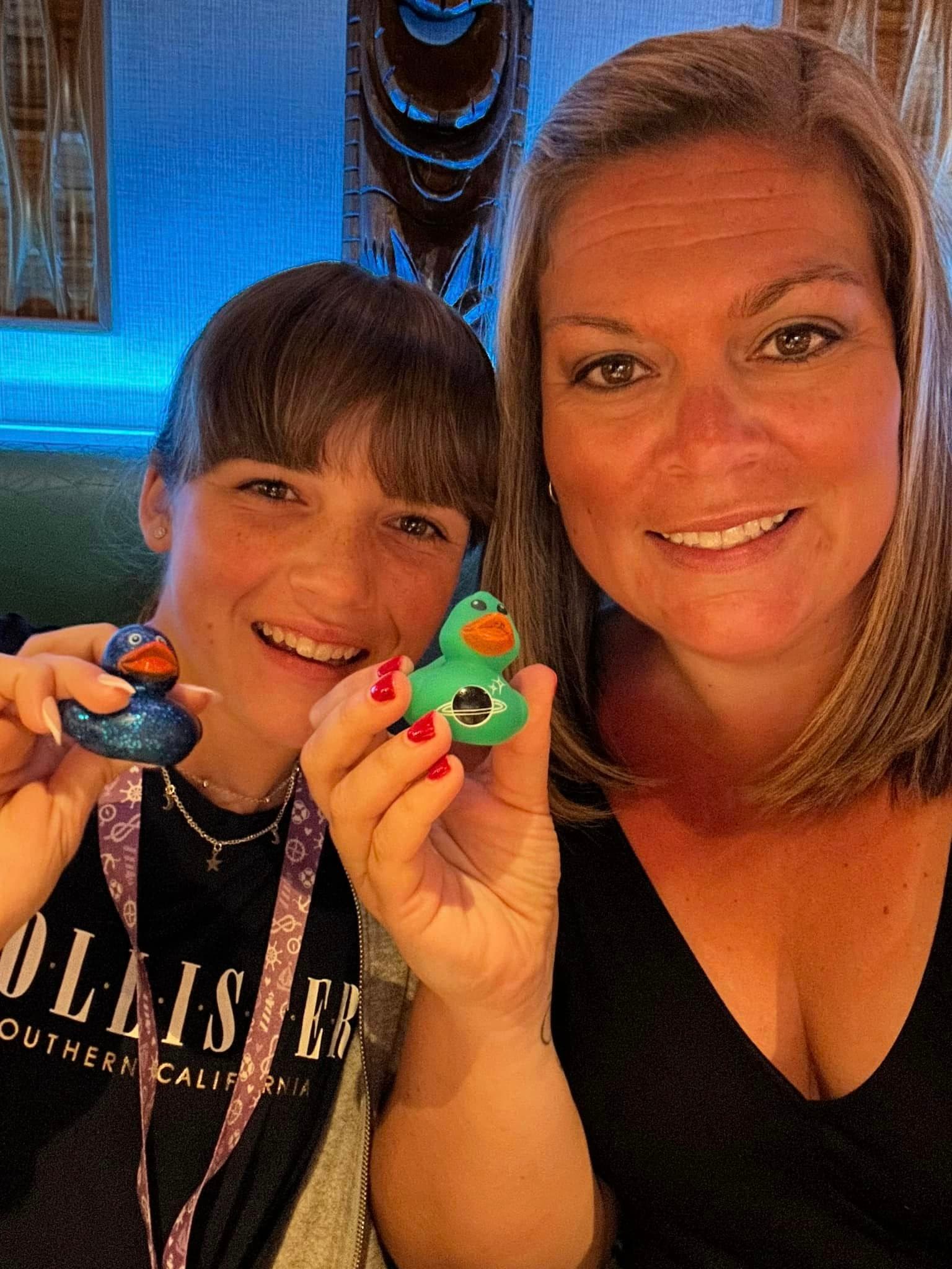 A family posing for a selfie photo holding mini rubber ducks