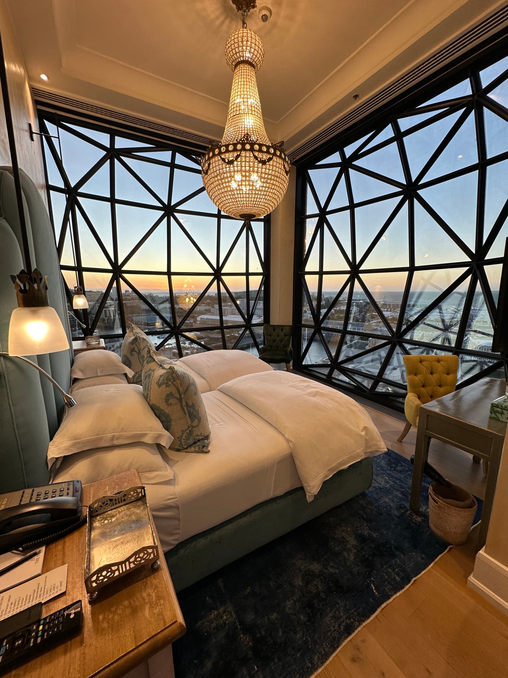 Inside one of the bedrooms in the Royal Suite at The Silo Hotel, with floor-ceiling glass walls and a view of Cape Town below.