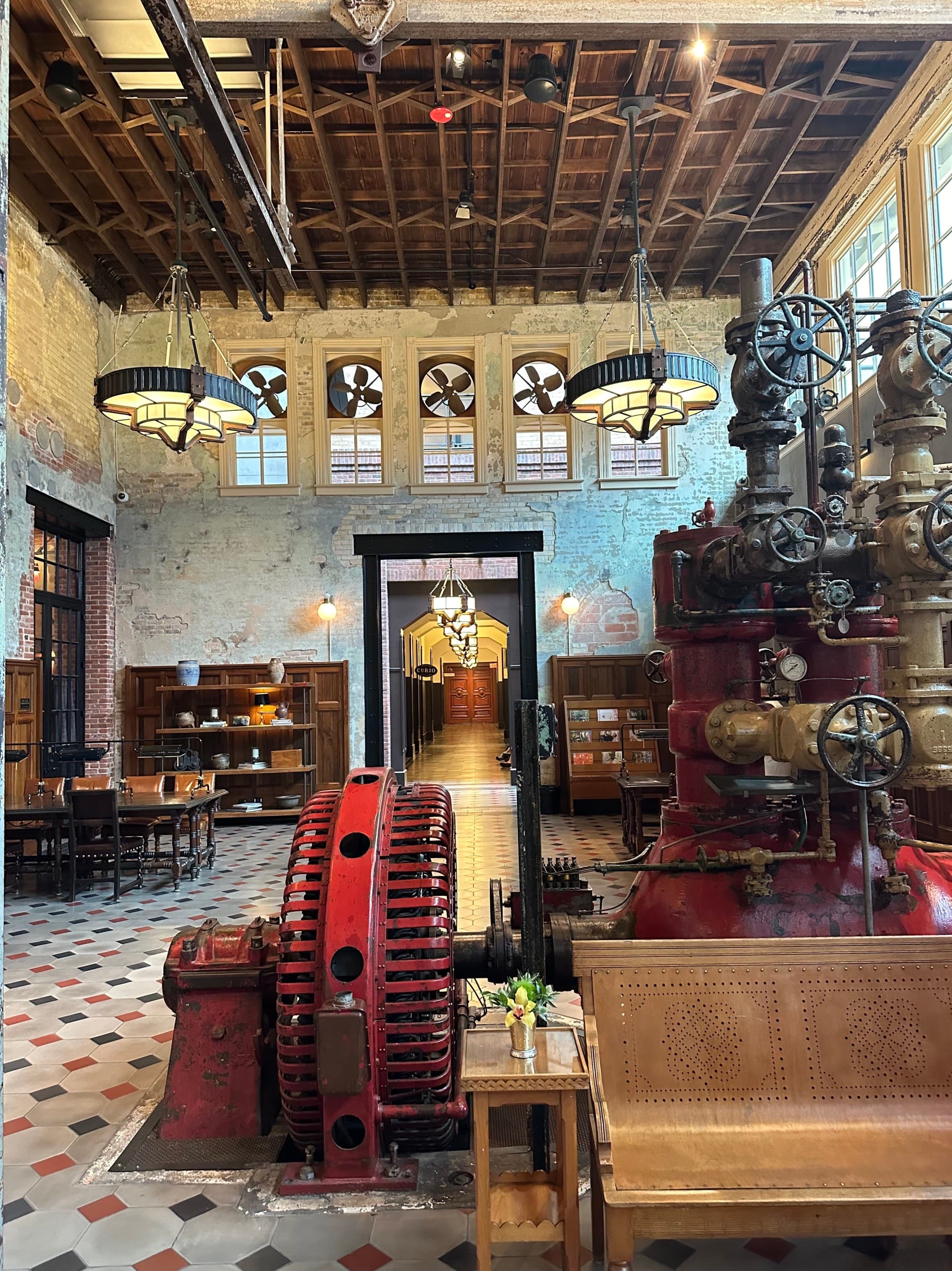 An old hotel lobby with lots of metal artifacts and decorations symbolizing the hotel's past life as a brewery.