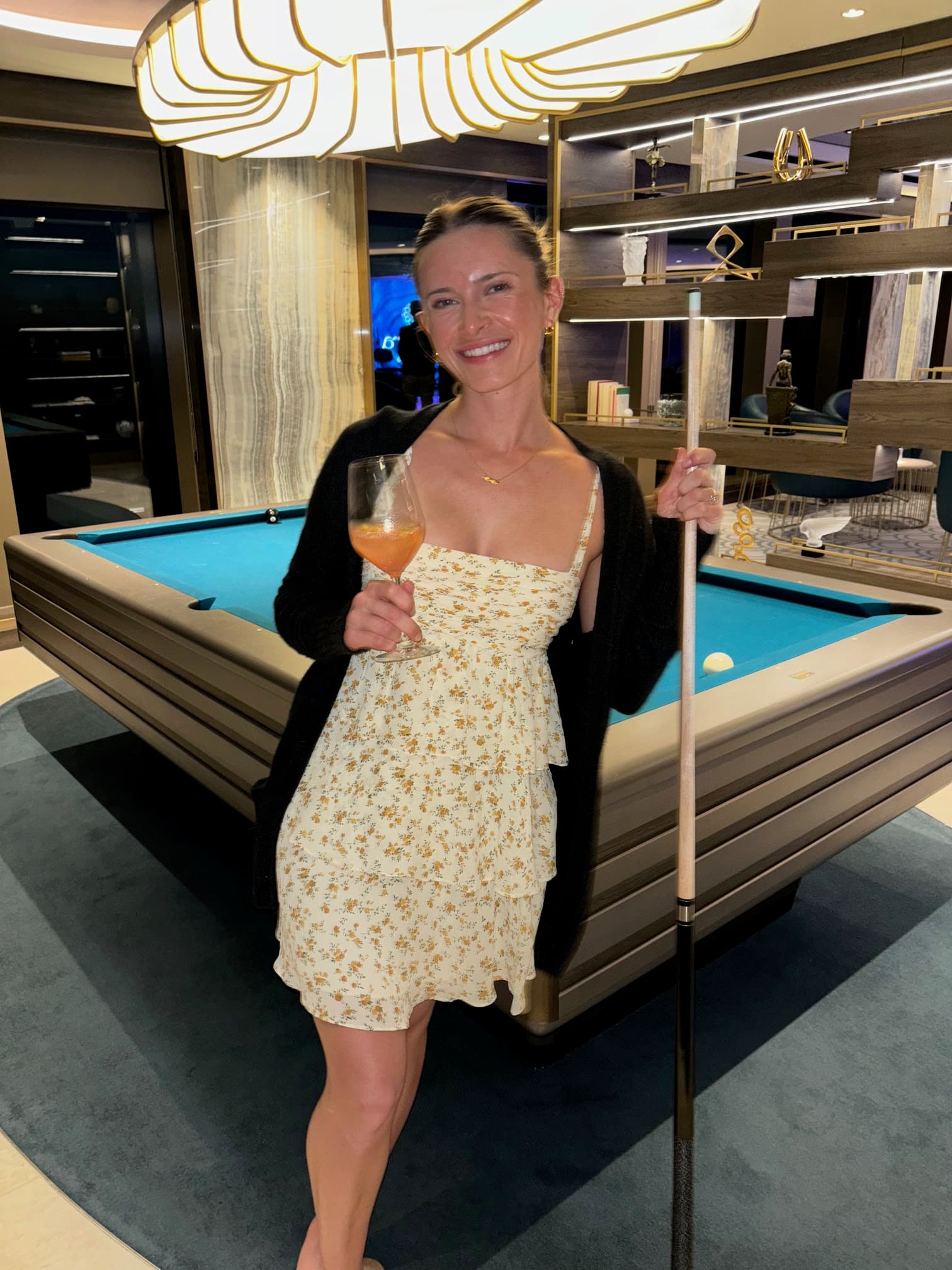 Alex in the Astern Lounge with a drink standing next to a pool table