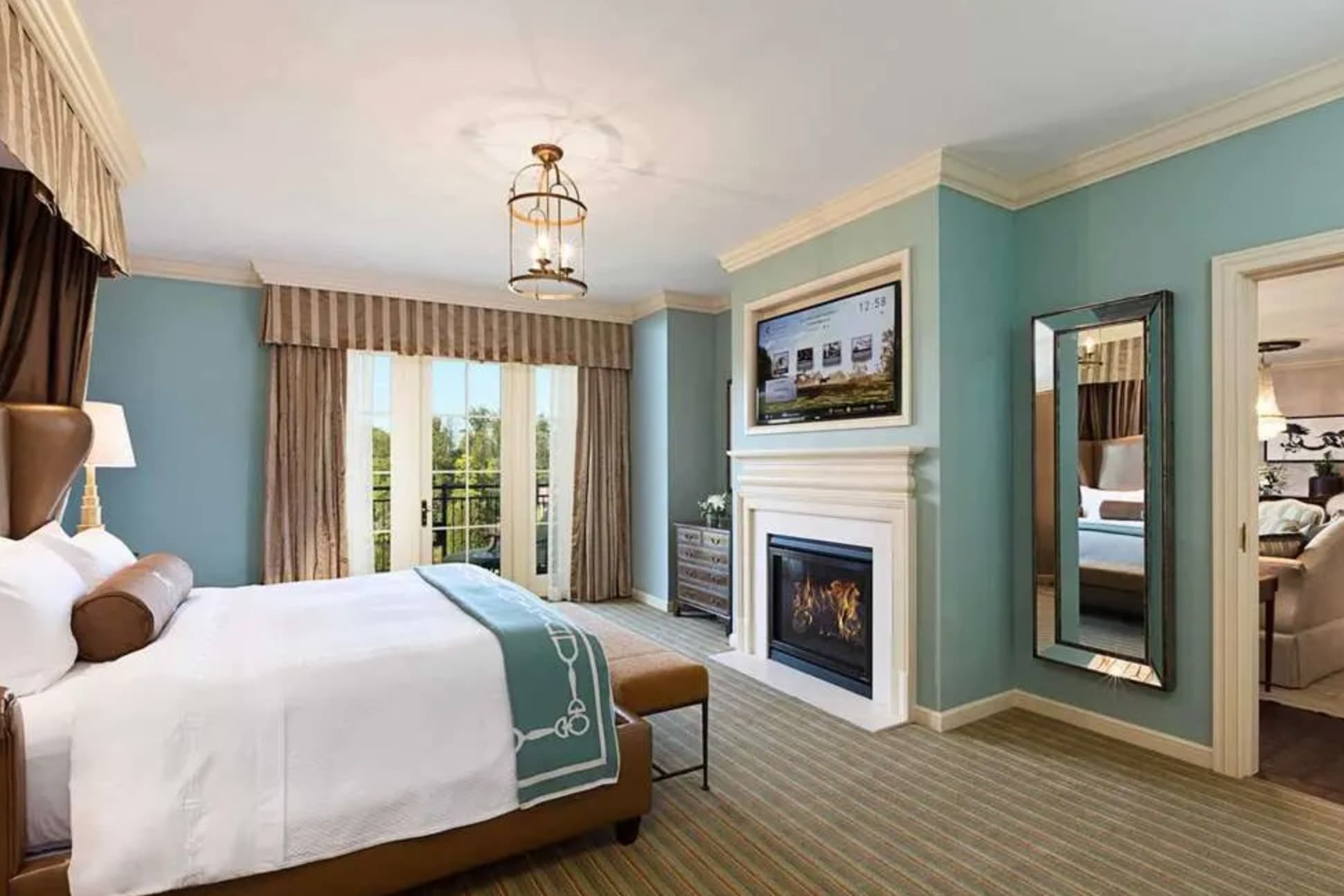 blue and white bedroom with fireplace and doorway to sitting room