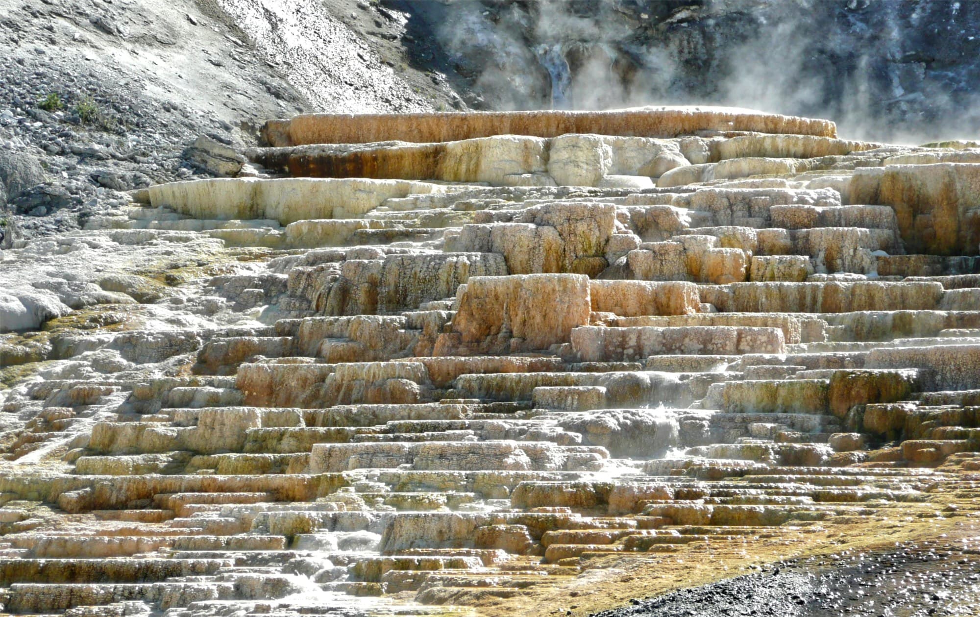 tan and white terraced rock in a hot springs