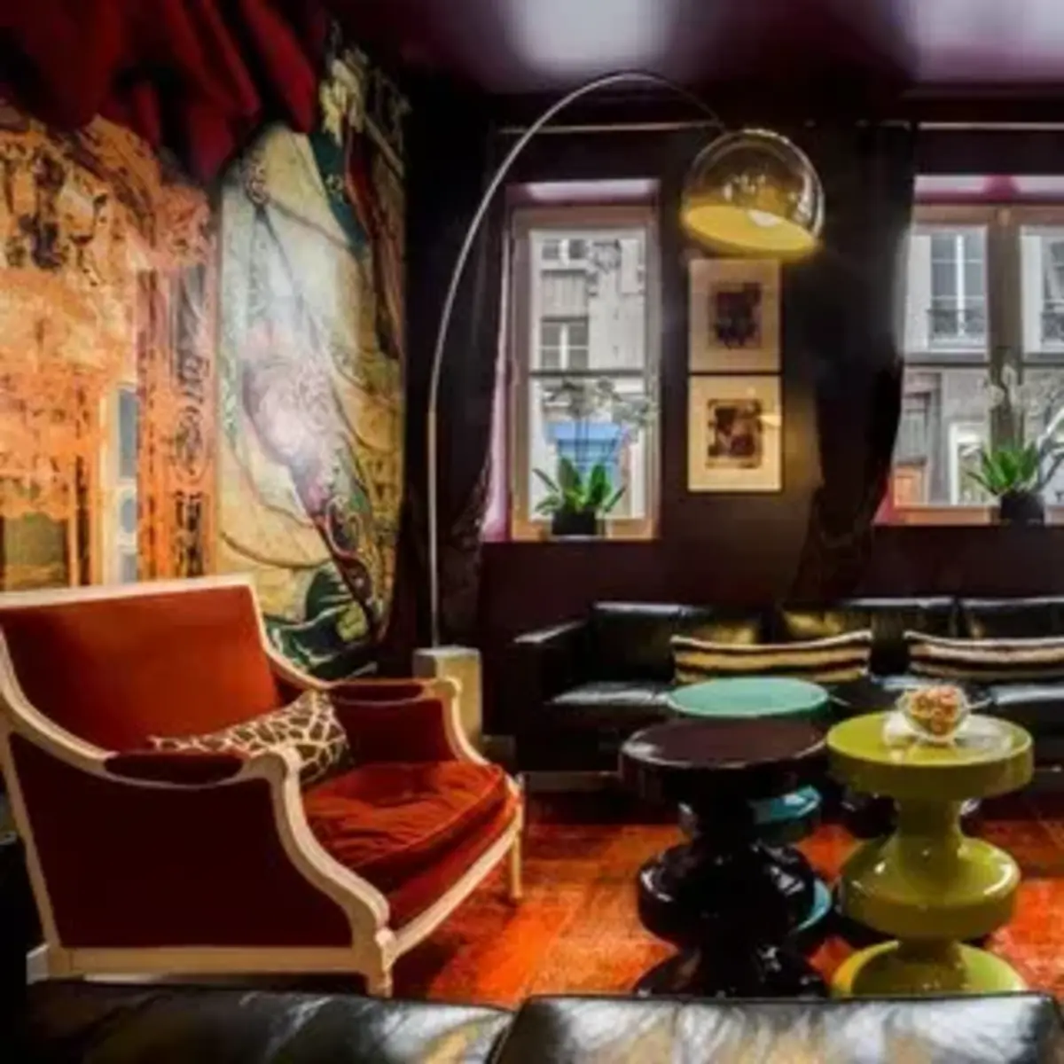 a vibrant salon with red an green upholstered velvet couches