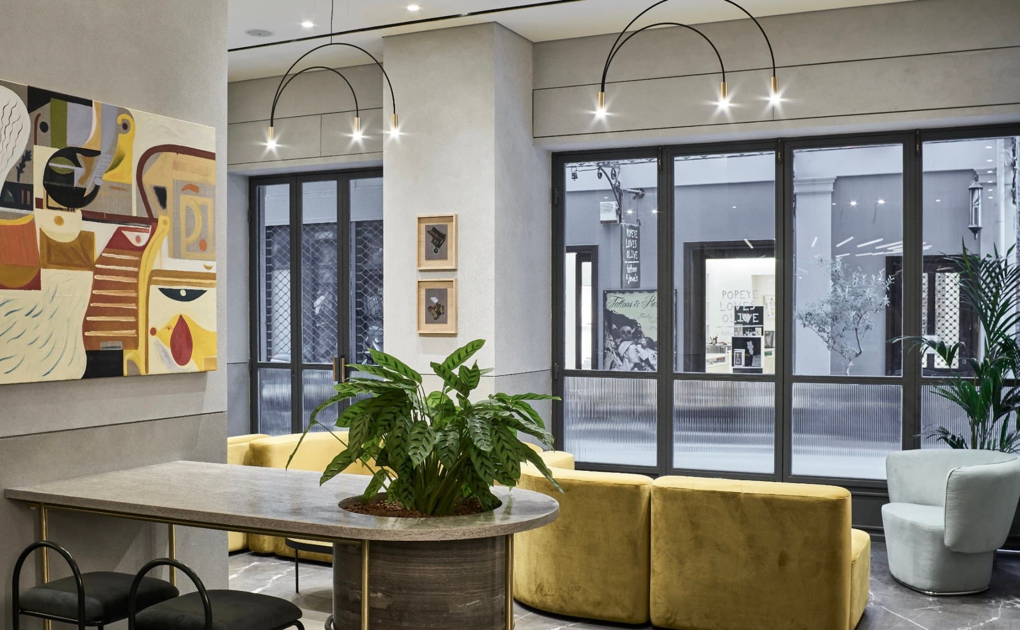 colorful lobby with contemporary lighting and yellow upholstered chairs