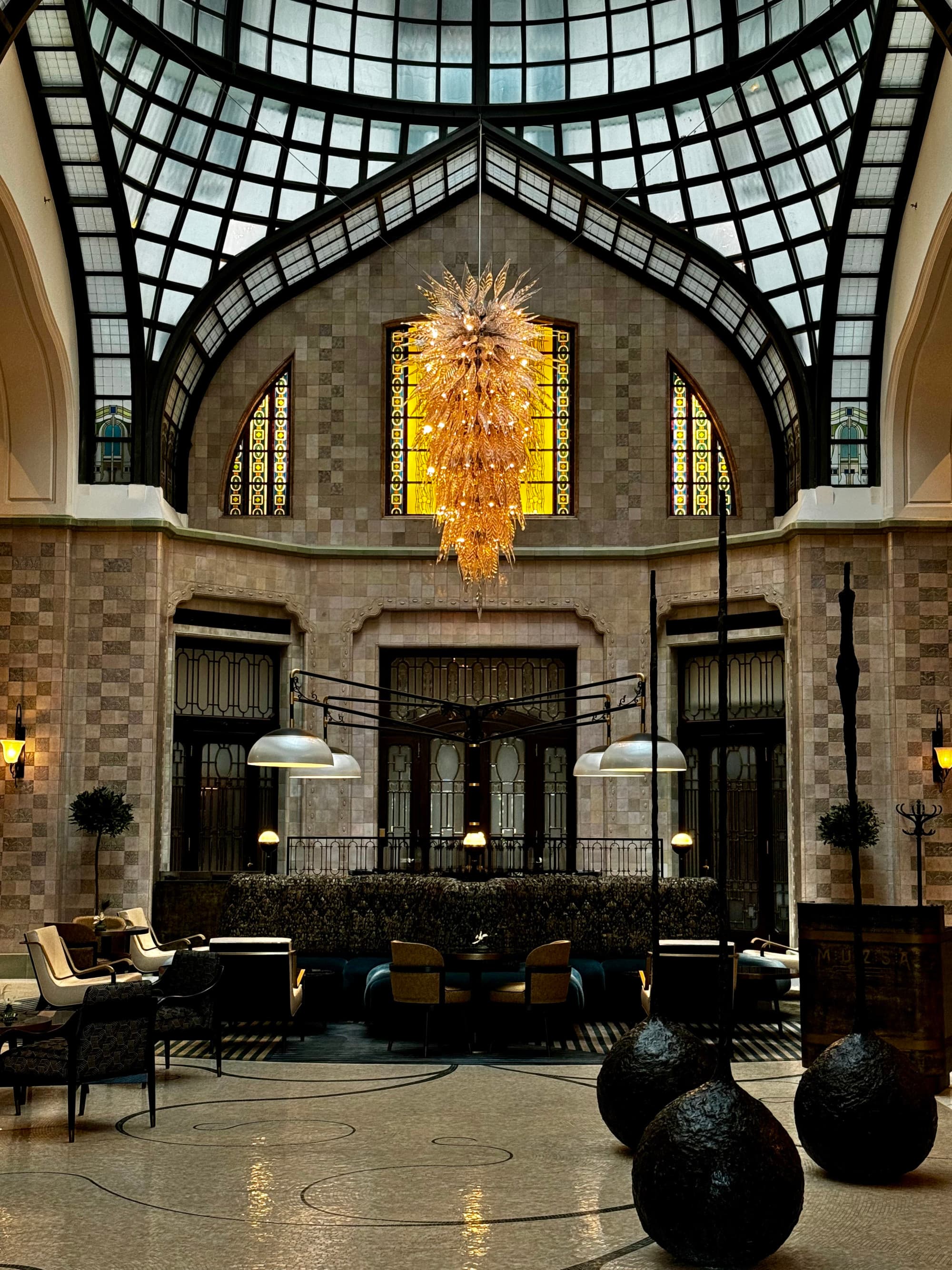Lobby with glass ceiling and blown glass chandelier.